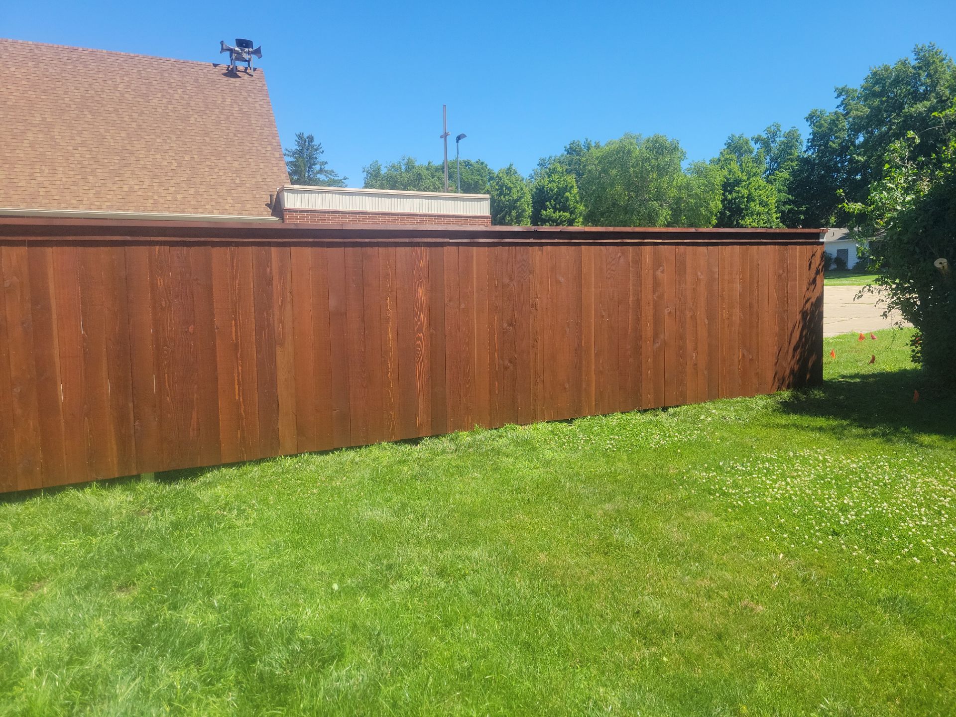 Custom Stained Cedar Chestnut Privacy Fence Installation in Cedar Falls by Perfect Picket Fence and Stain