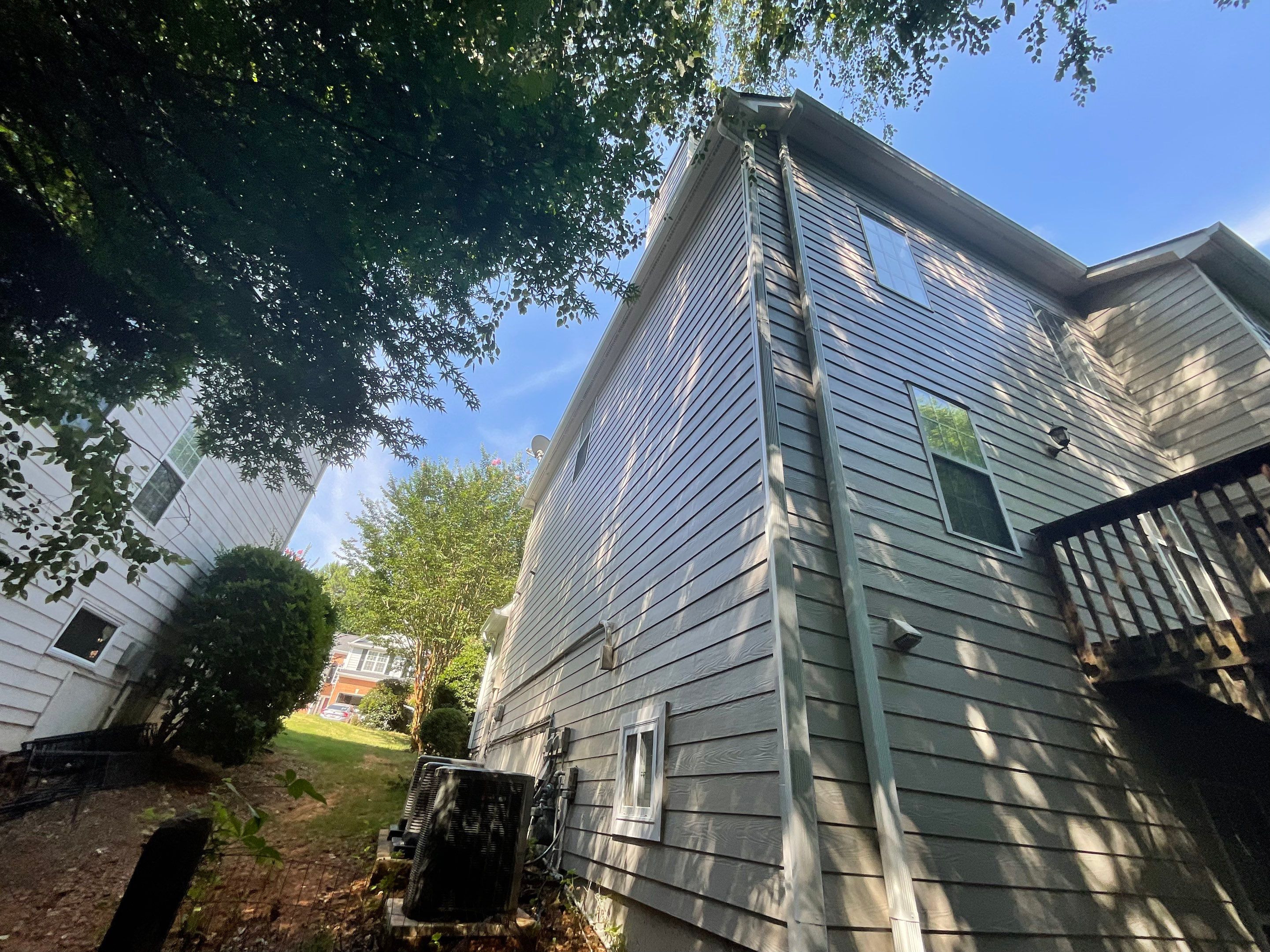 Stucco and Siding Exterior Painting with New Gutters in Kennesaw by Swift Home Renovations