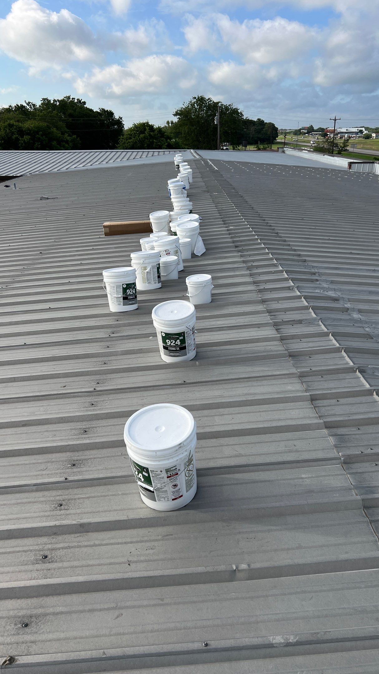Commercial Roofing Installation using TRP #924 Eterna-Sil Premium Silicone Roof Coating by Harvey Roofing & Construction