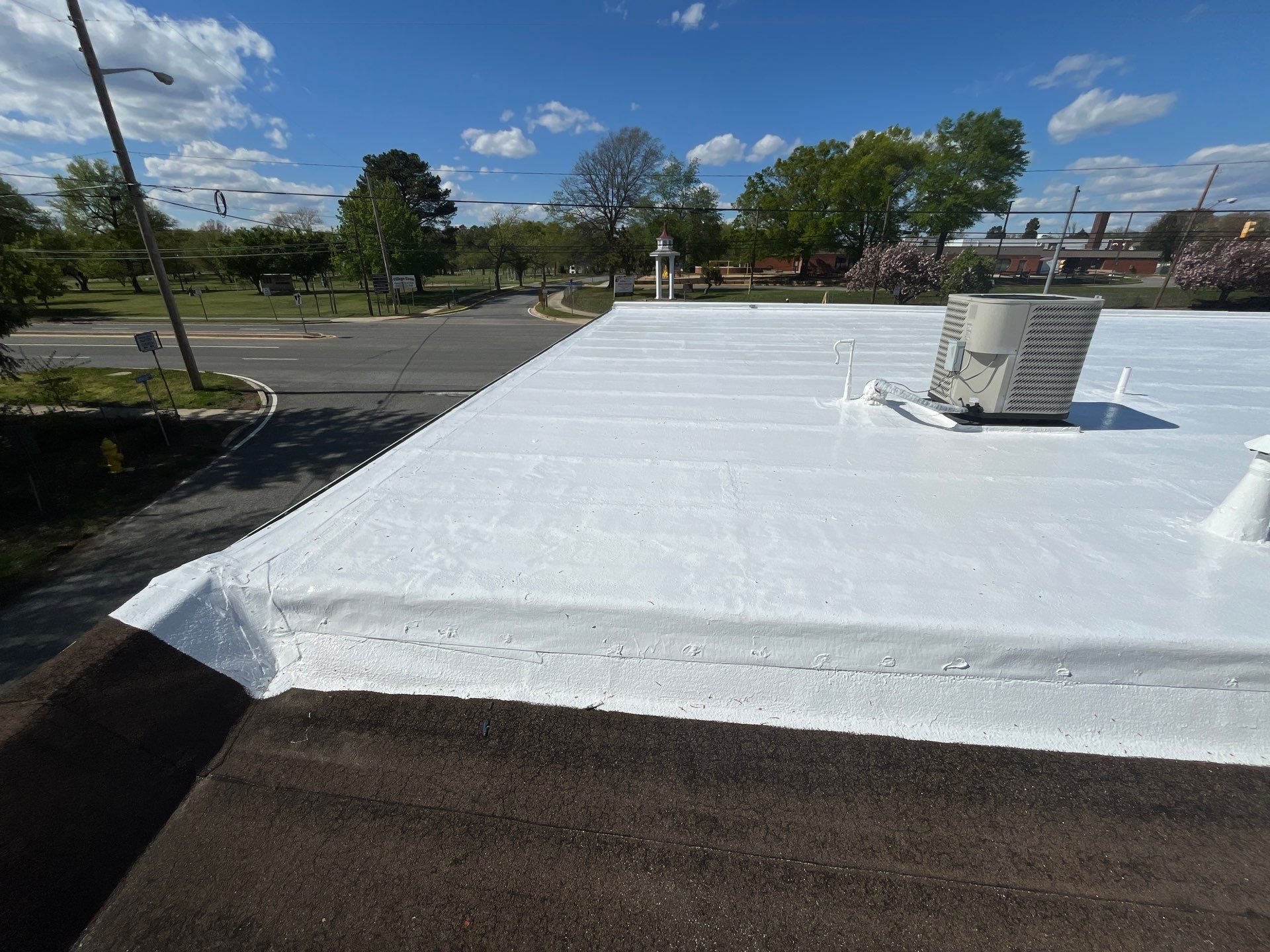 Roof Installation using Silicone Modified Flat Roof Coating by ExteriorPros