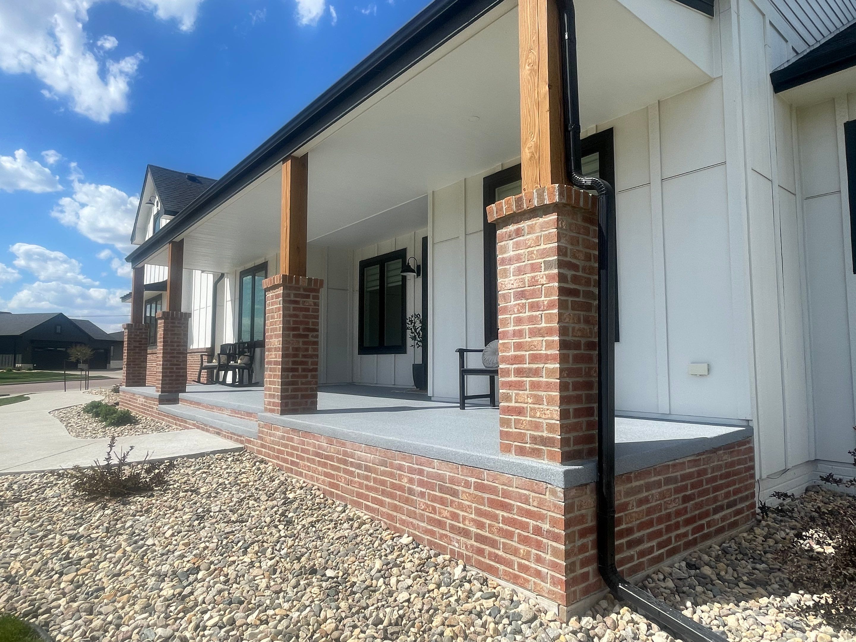 Grey Speckled Concrete Porch Coating for Sioux Falls Home by Select Painting, Coatings & Garage Cabinets