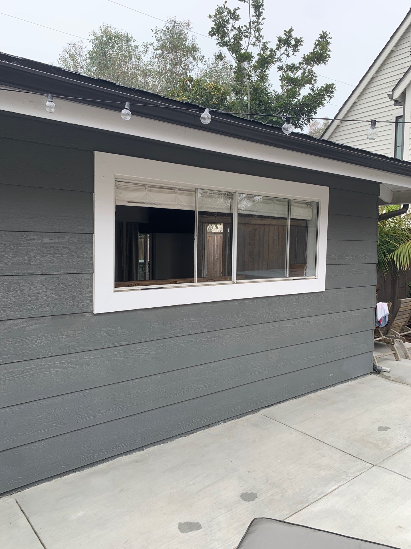 Window Installation using Milgard black vinyl windows by American Window Company