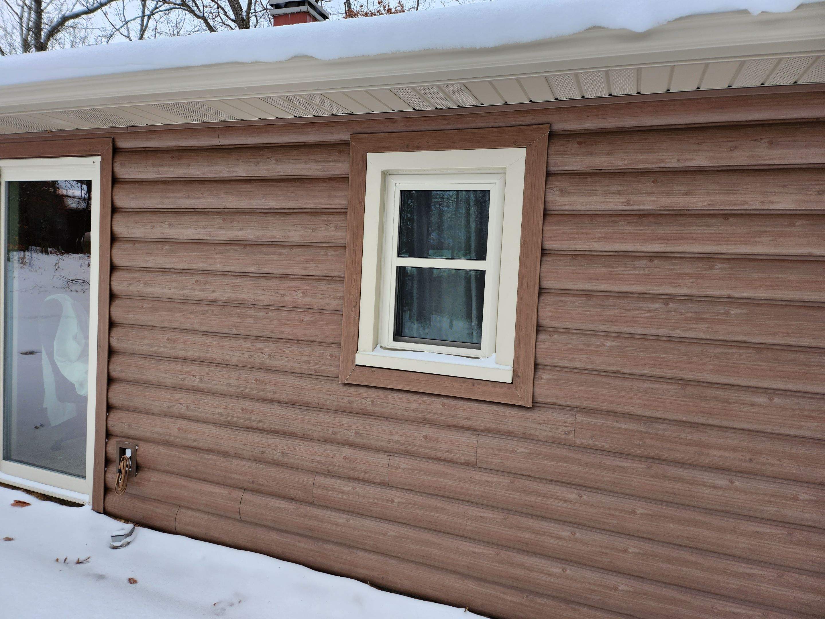 New addition and log siding by Energy Plus Home Improvements