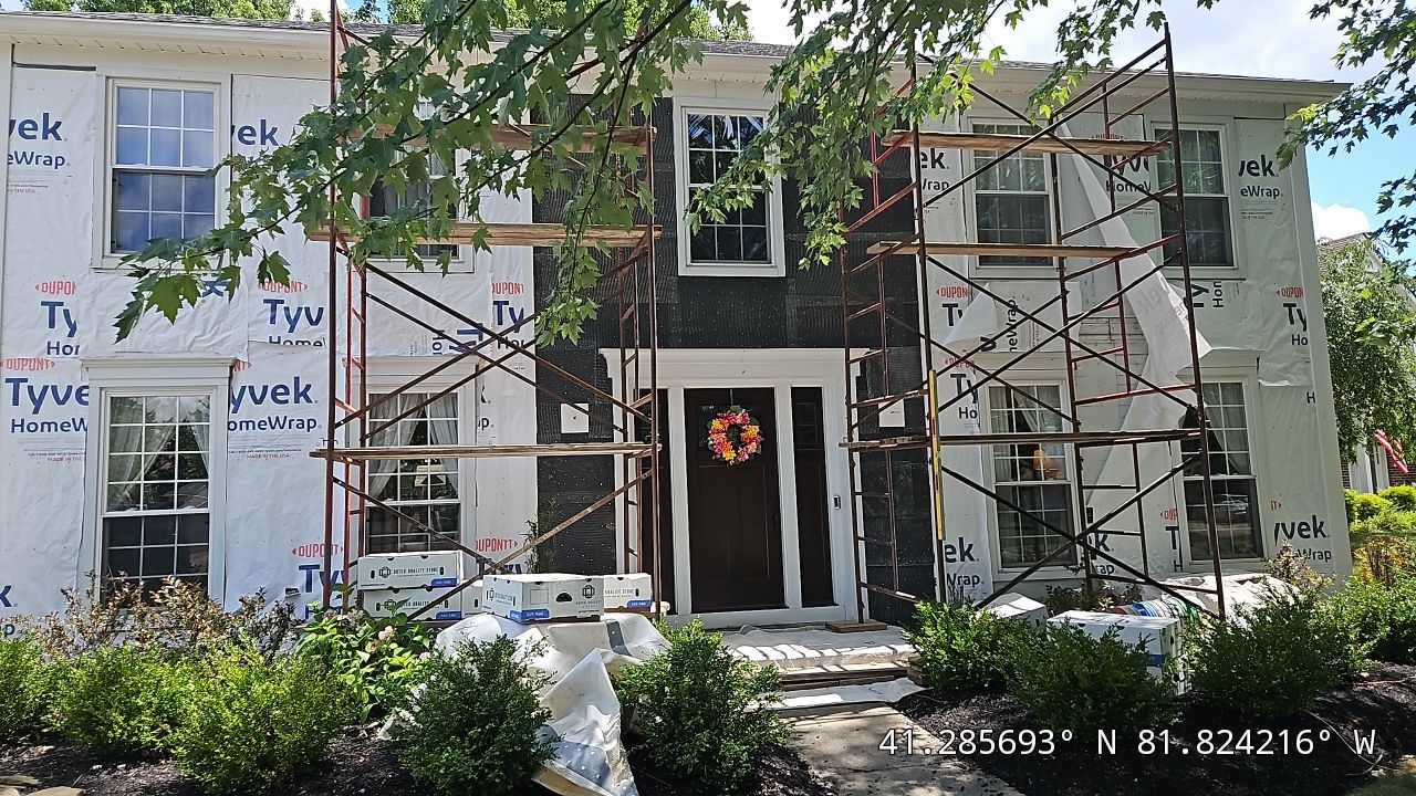 Vinyl Siding w. Stone Facade by Absolute Roofing and Construction