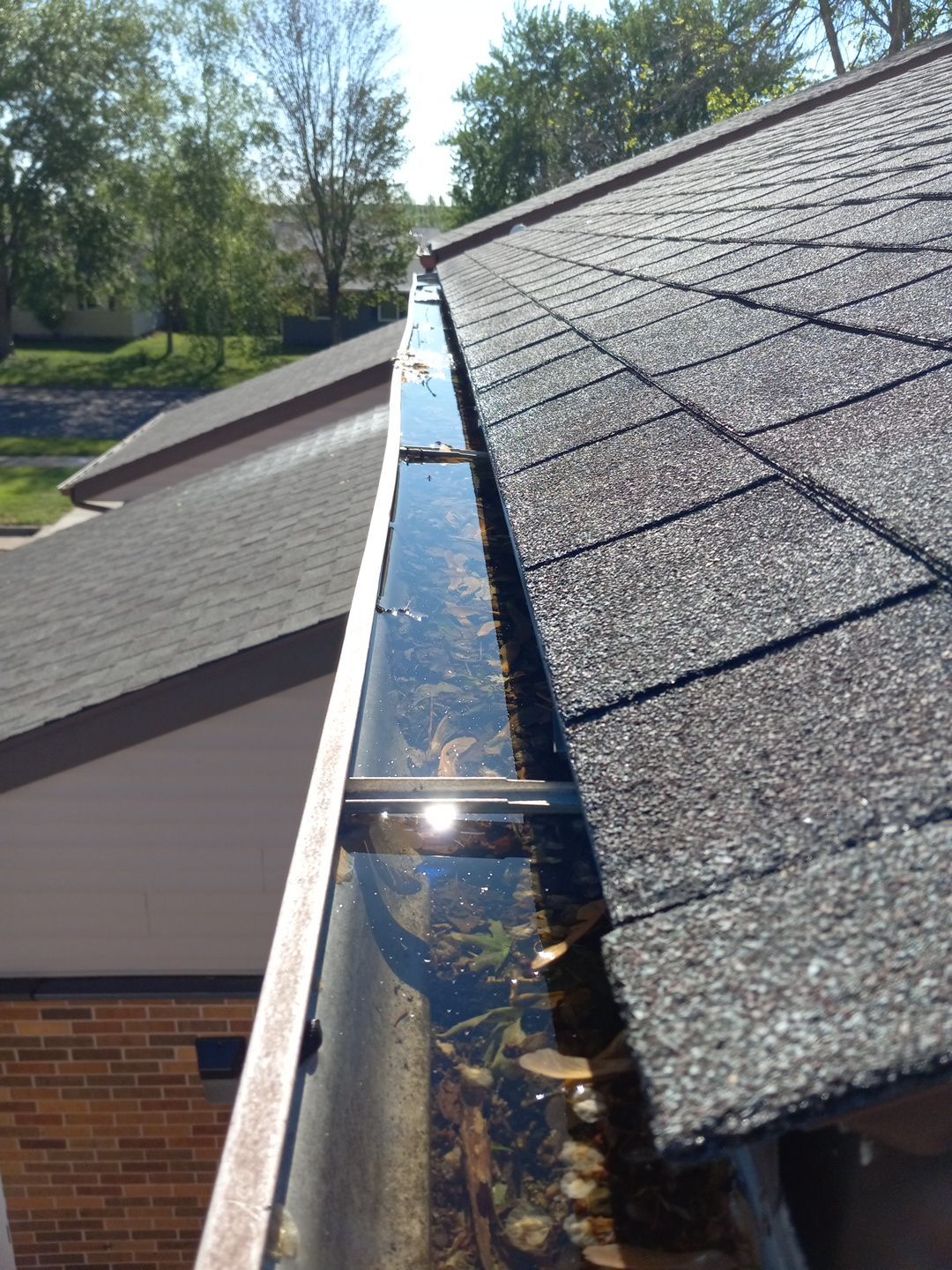 Commercial gutter cleaning Wisconsin before photo with filled gutters