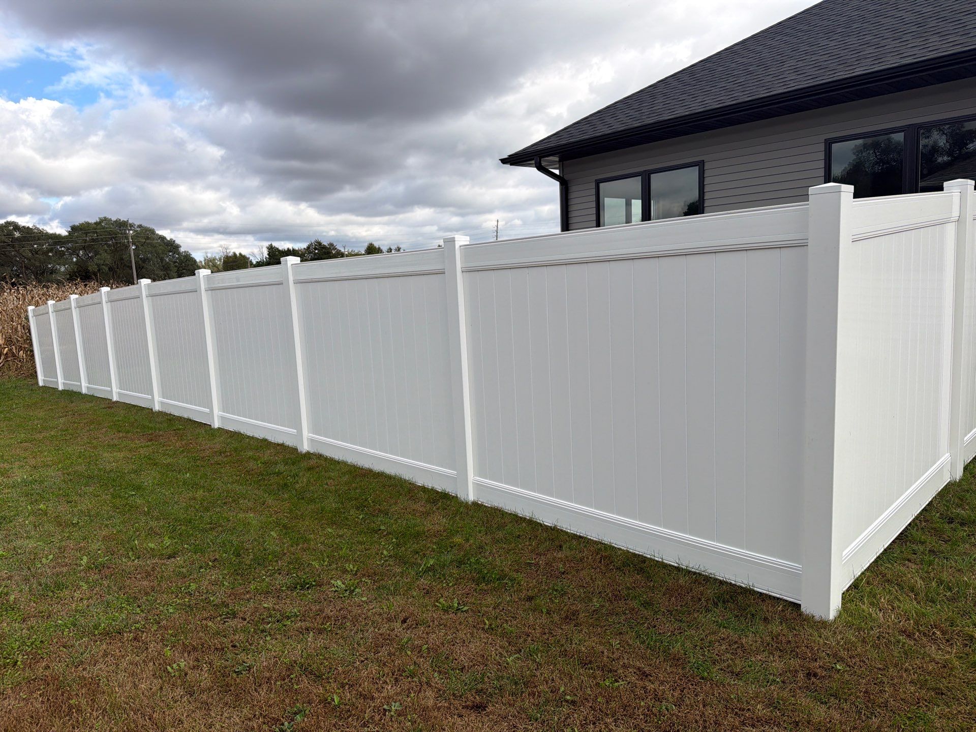 Residential White Vinyl Privacy Fence Installation in Janesville by Perfect Picket Fence and Stain