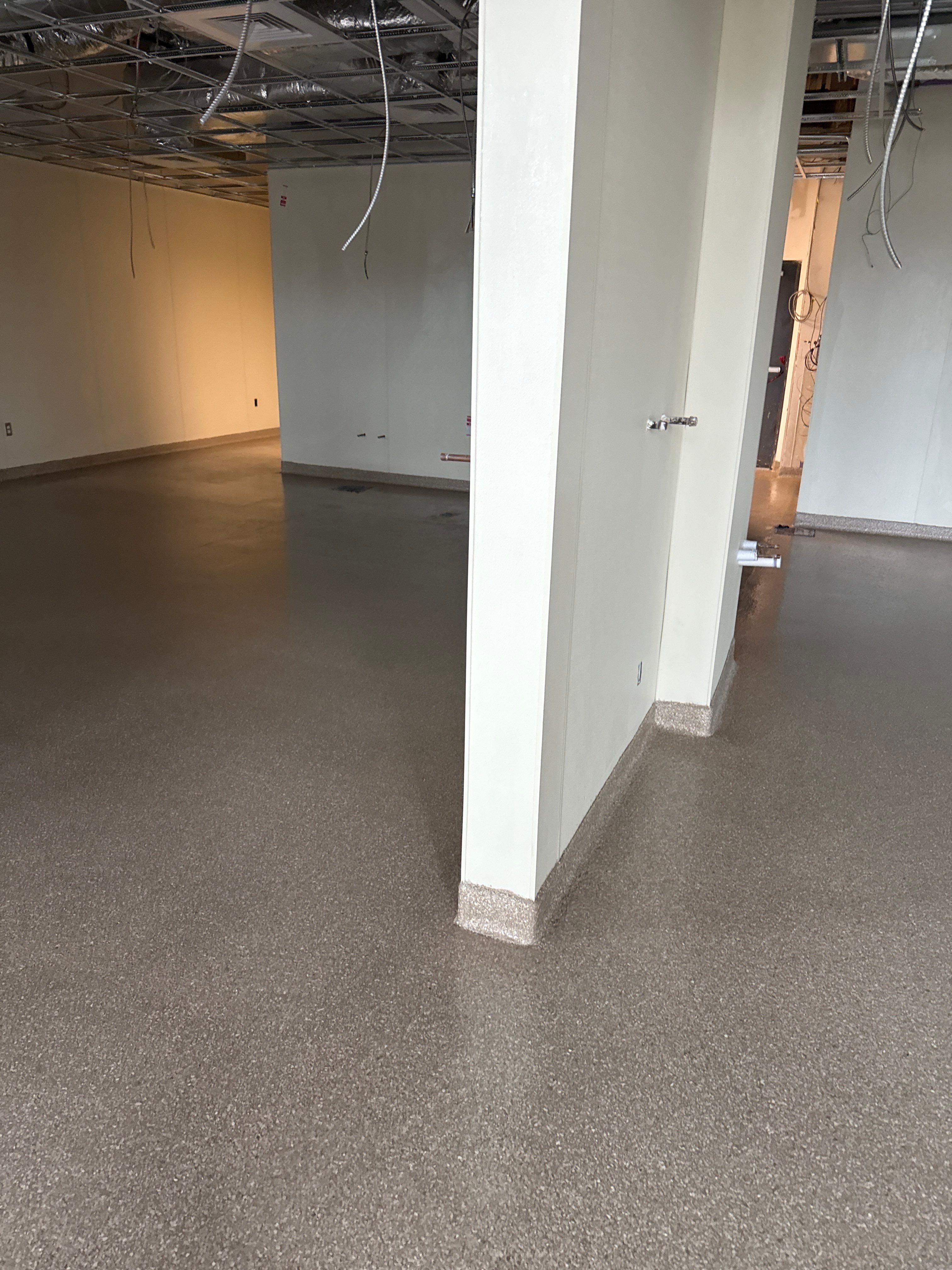 Industrial Epoxy Flake and Concrete Overlay Floor Installation in Pensacola by Cornerstone Hard Surface Restoration