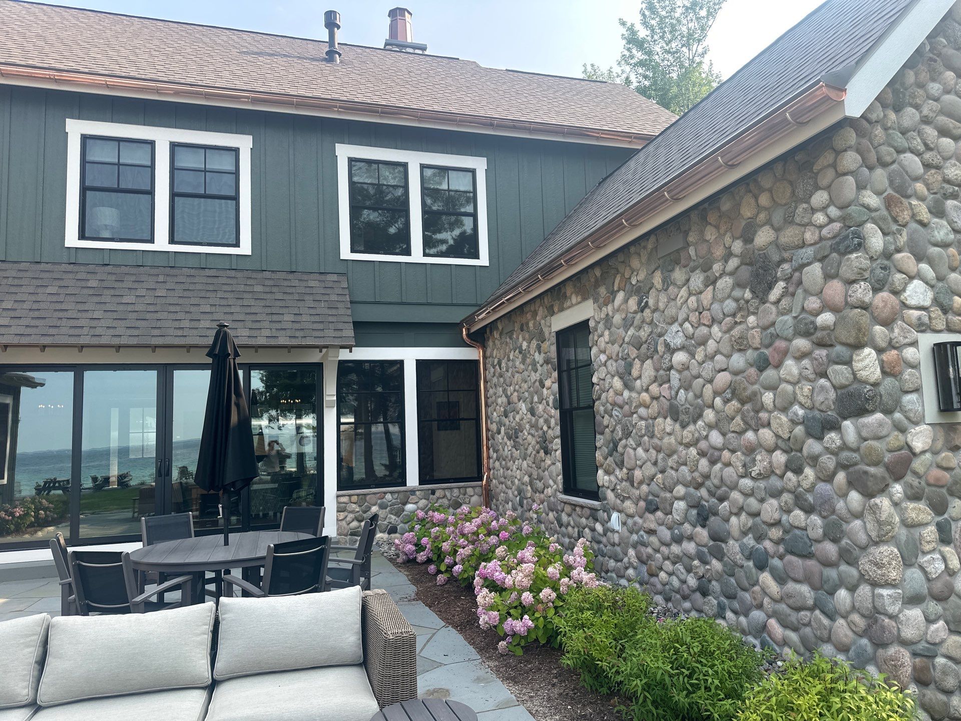 Copper Gutter and Downspout Installation for Omena Residence by Rainbow Seamless Systems