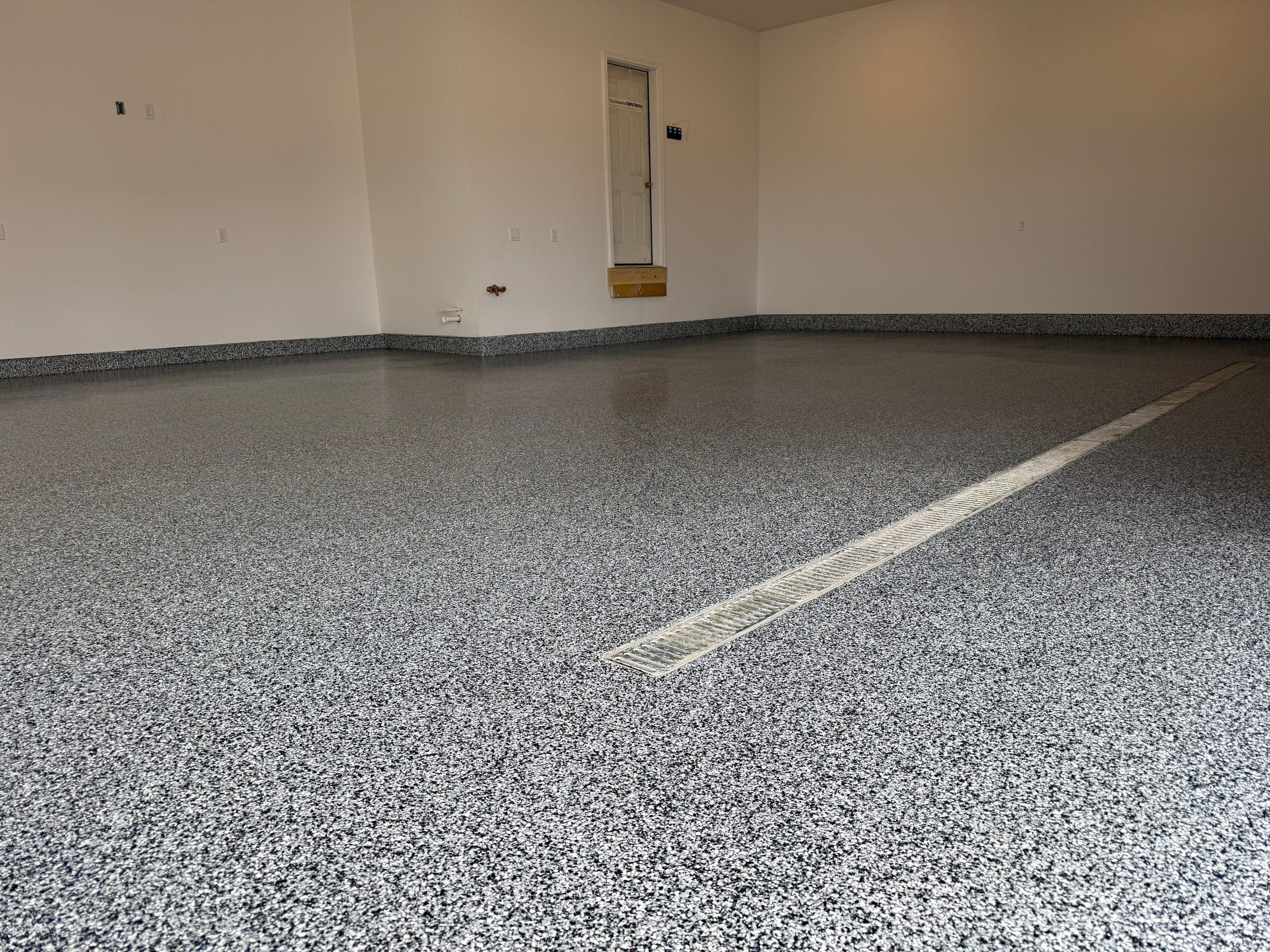 Multi-Car Garage Epoxy Floor Coating and Concrete Finishing in Sioux Falls by Select Painting, Coatings & Garage Cabinets