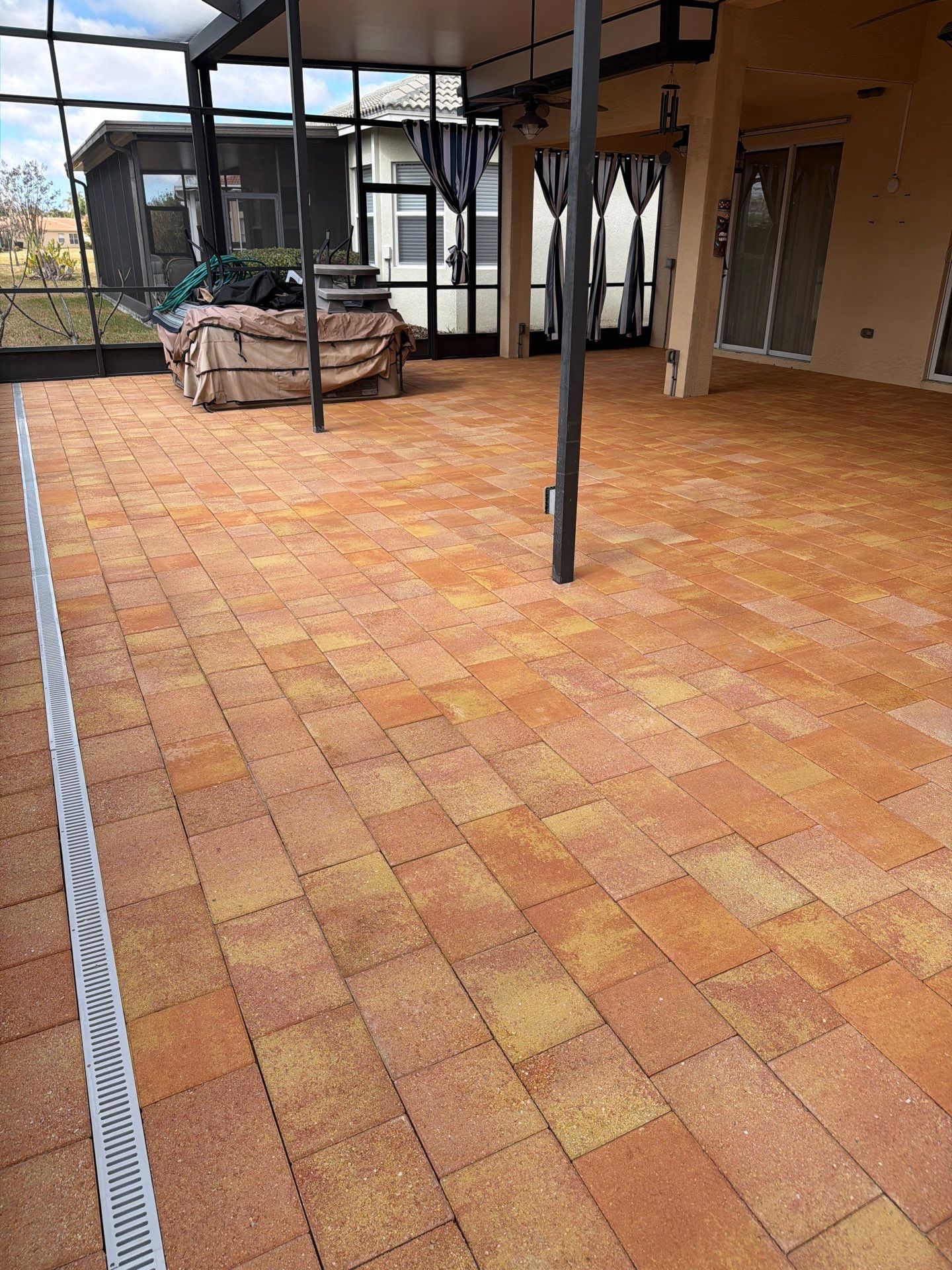 Paver Sealing for Herringbone Driveway and Screened Lanai in Valencia Lakes by Supreme Paver Experts