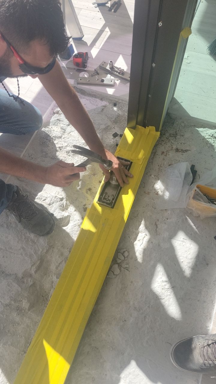 Custom Material Pivot Door installation by Impact Precious Wood Inc.