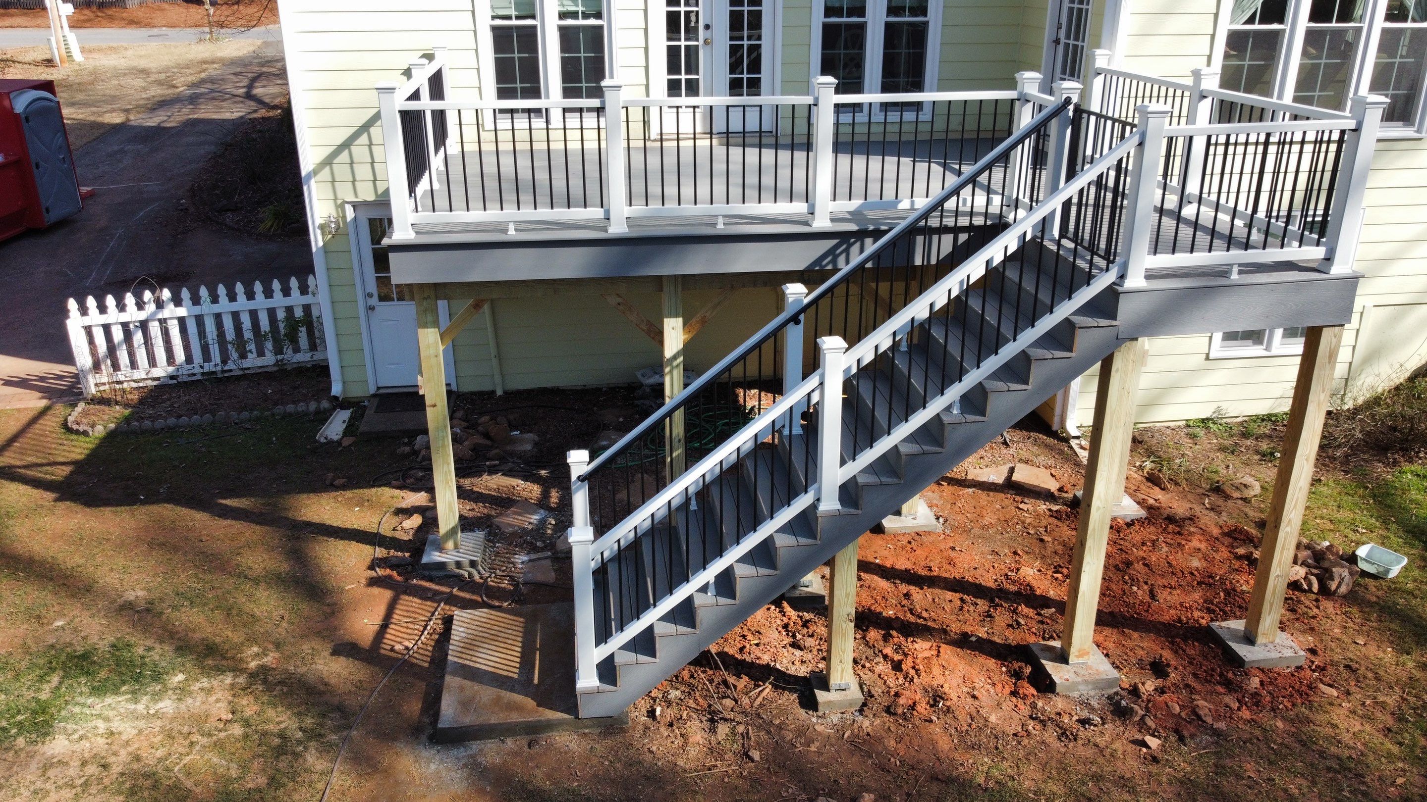 Elevated Grey Composite Deck Installation in Woodstock, Georgia by Swift Home Renovations