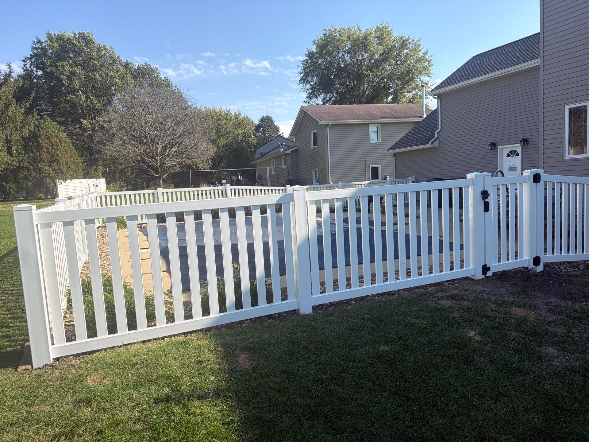 White Vinyl Picket Pool Fence Installation in Waterloo, Iowa by Perfect Picket Fence and Stain