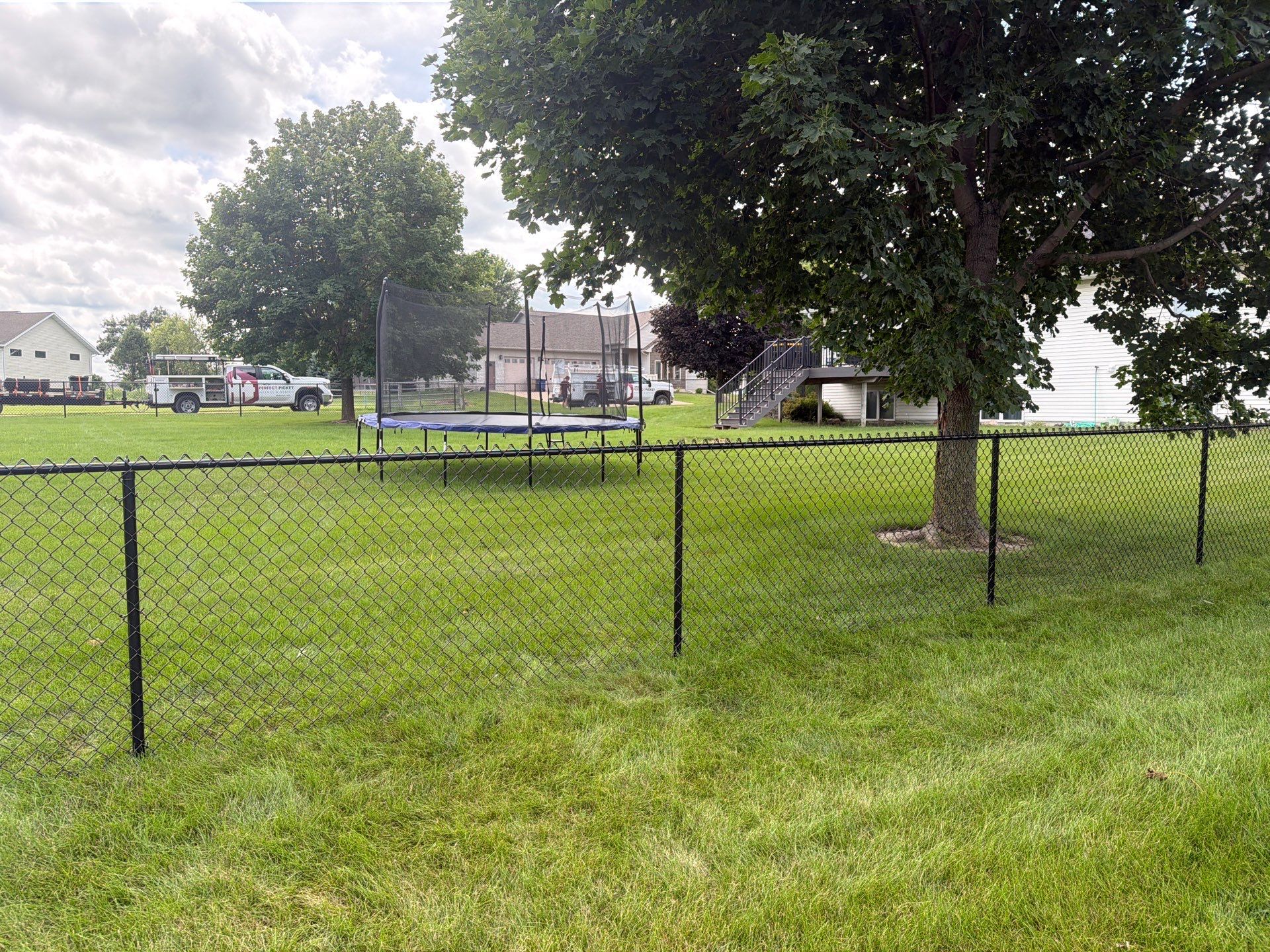 Black Vinyl-Coated Chain Link Fence Installation in Fairbank by Perfect Picket Fence and Stain