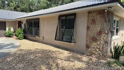 Hurricane Rated Bahama Shutters in Gray Brown
