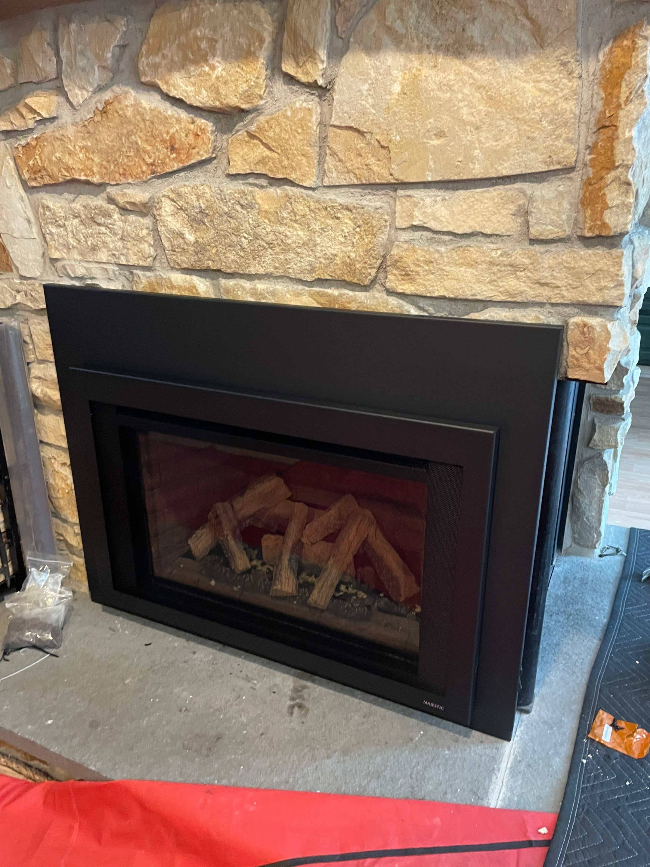 Gas Insert in corner fireplace by Neighborhood Chimney Services 