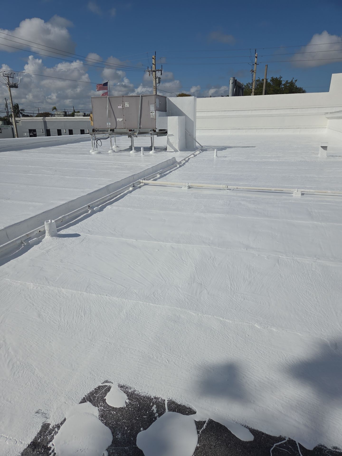 Commercial Flat Roof Restoration Using Silicone Coating in Hallandale Beach by Aastro Roofing