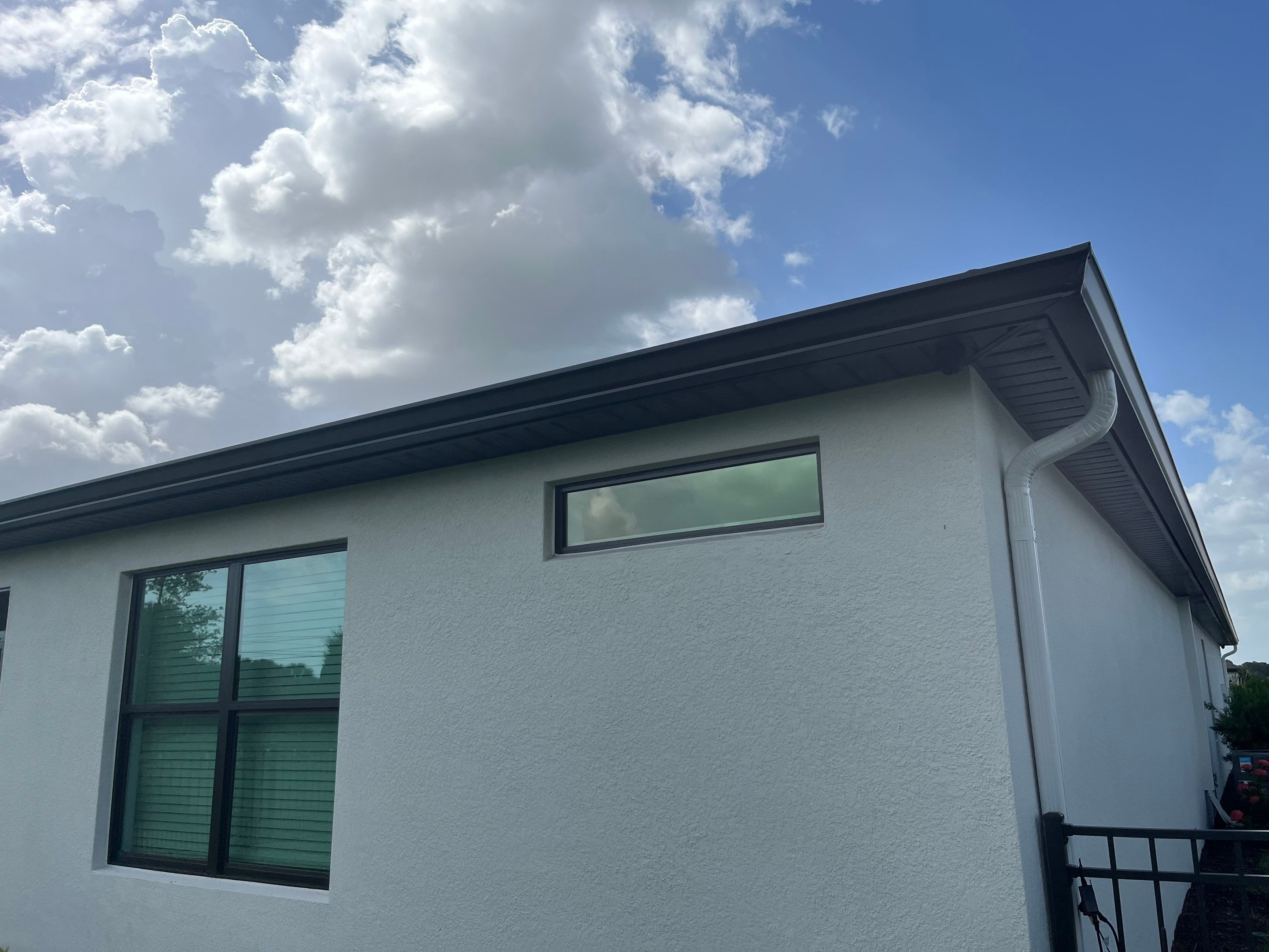 Dark Bronze Gutters and White Downspouts in Sarasota FL by Gutter Professors