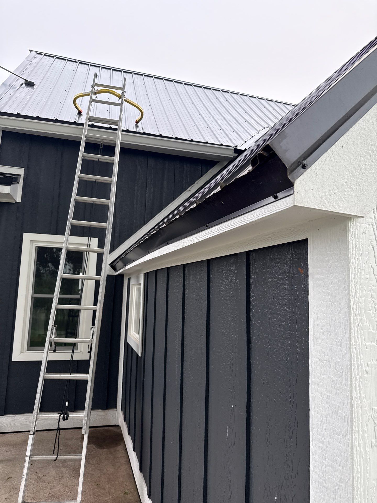 Seamless Gutter and Gutter Helmet Installation on Bellaire Metal Roof by Rainbow Seamless Systems