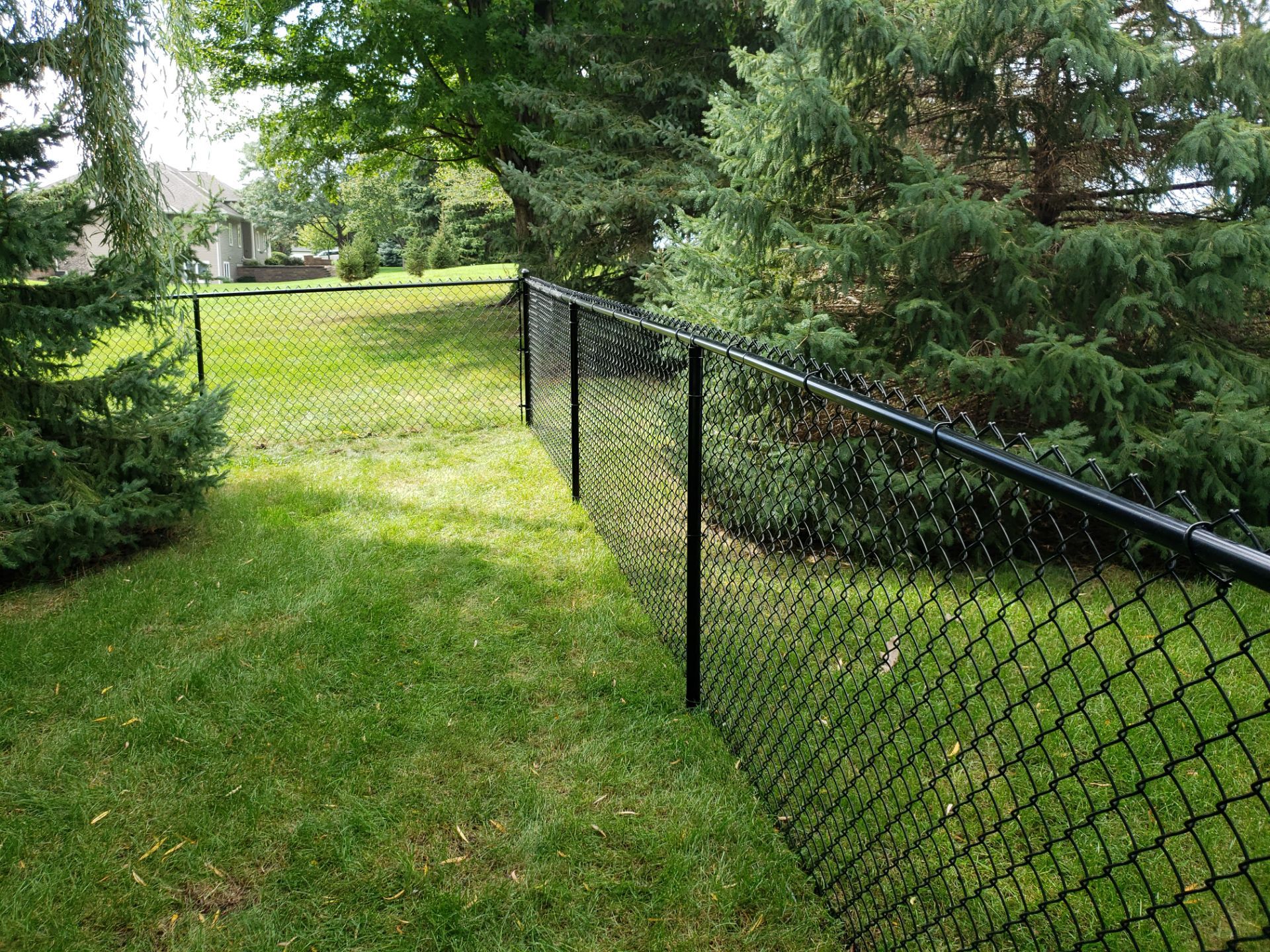 Black Vinyl-Coated Chain Link Fence Installation in Cedar Falls by Perfect Picket Fence and Stain