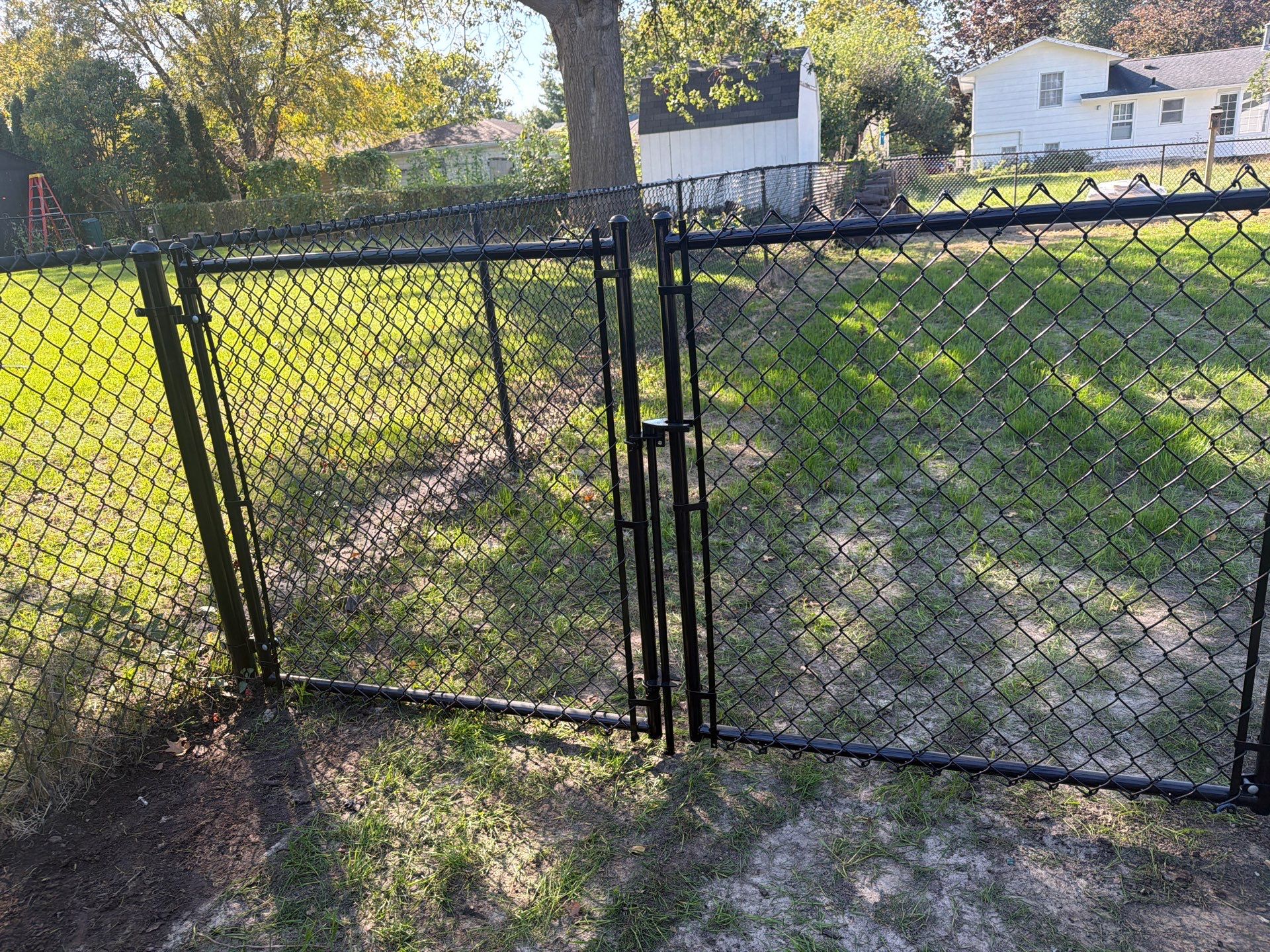 Black Chain Link Fence Installation with Double Gate in Cedar Falls by Perfect Picket Fence and Stain