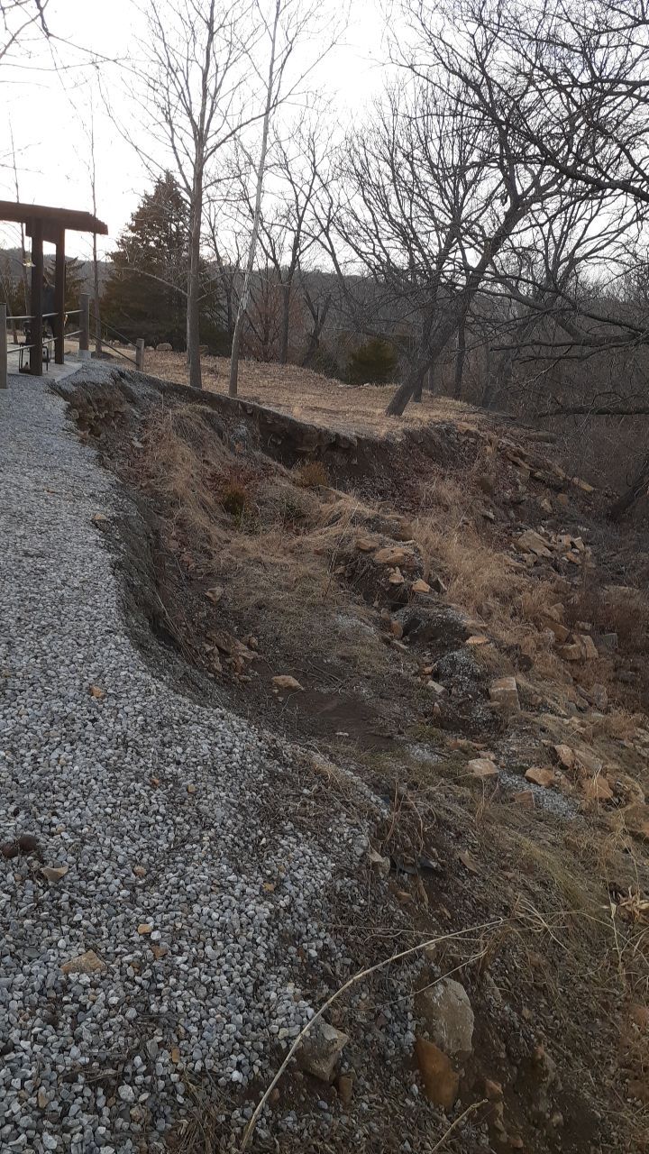 Supporting back of home with backfill at edge of steep creek by LAND ESCAPES LLC
