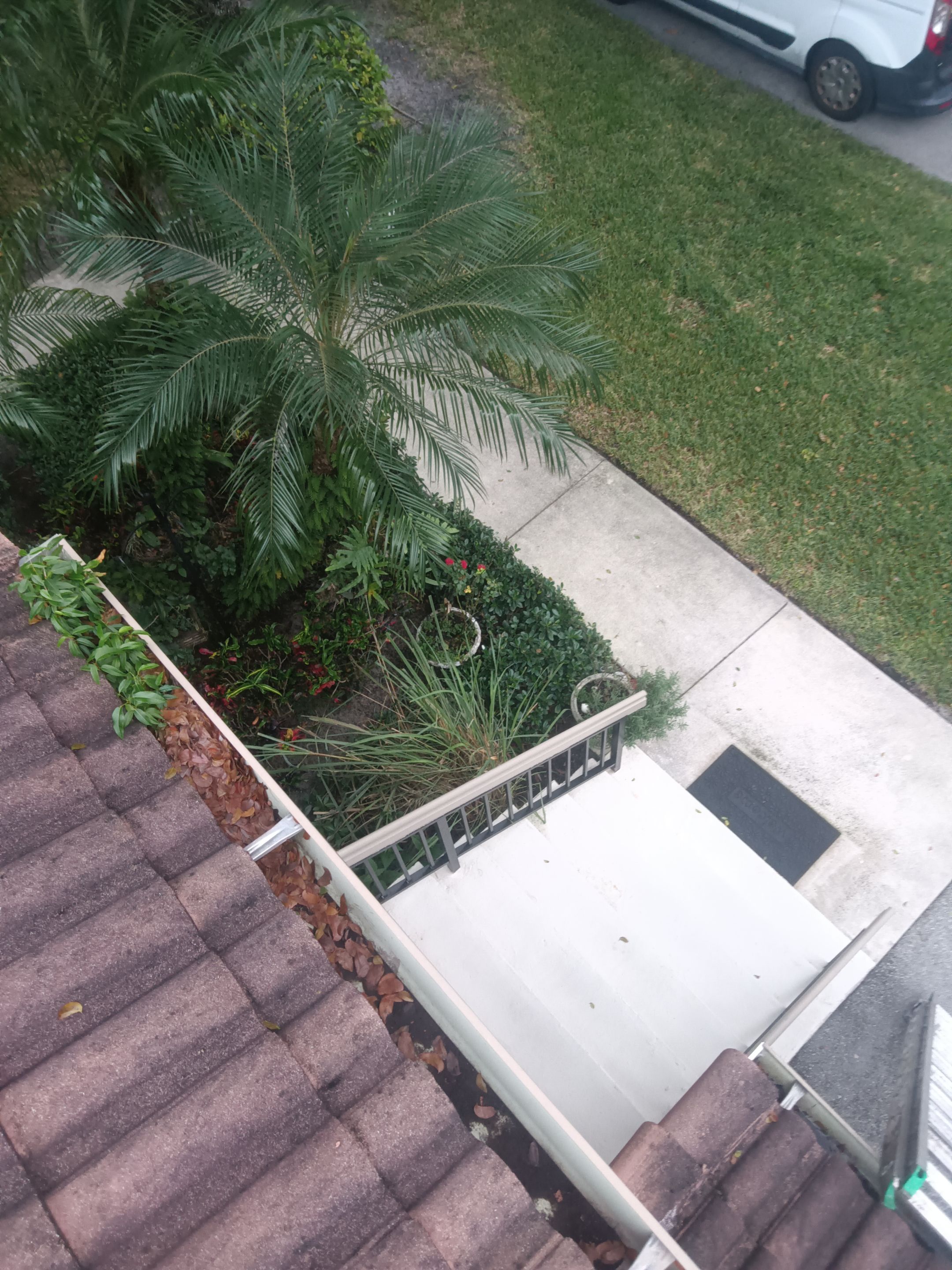 Commercial gutter cleaning Boca Raton & Delray Beach, FL before photo with filled gutters