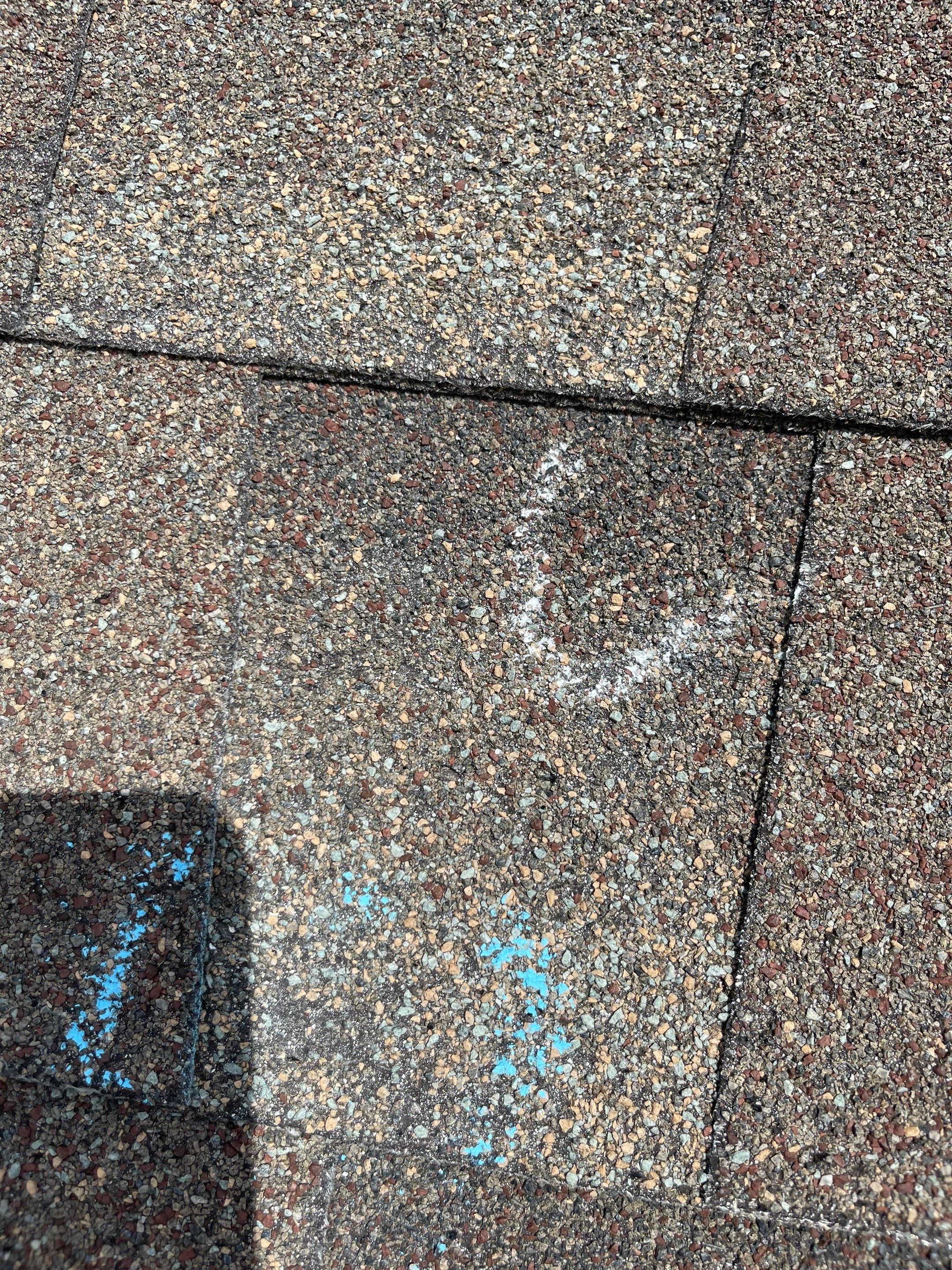 Hail Damage on a Roofing System by Icon Roofing And Construction 
