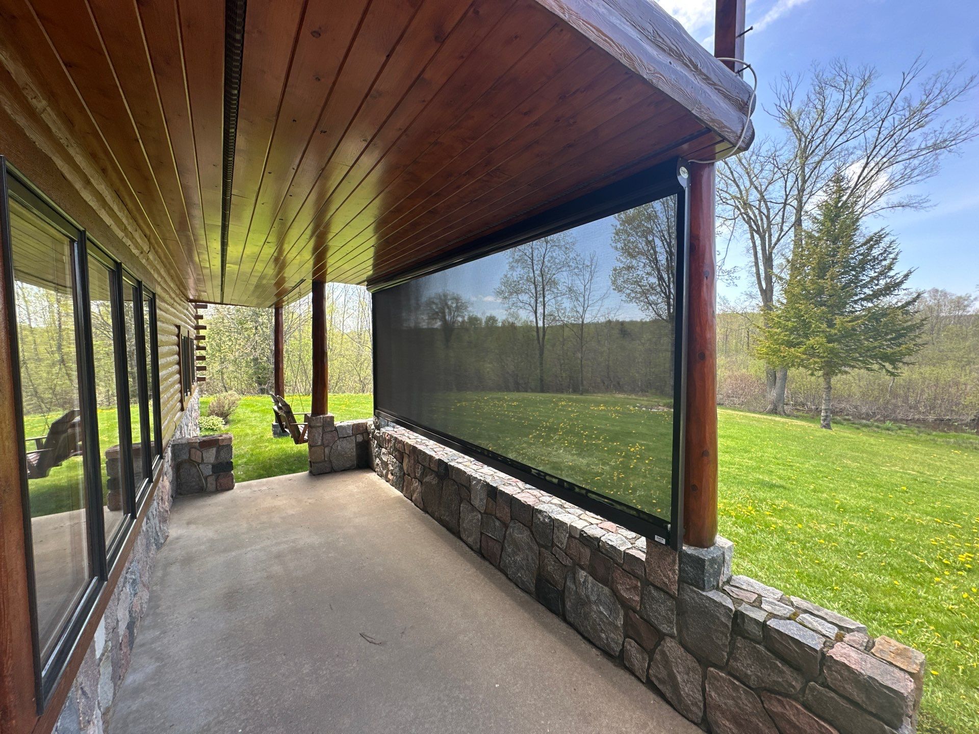 Sunesta Retractable Screen Installation on a Petoskey Log Home Porch by Rainbow Seamless Systems