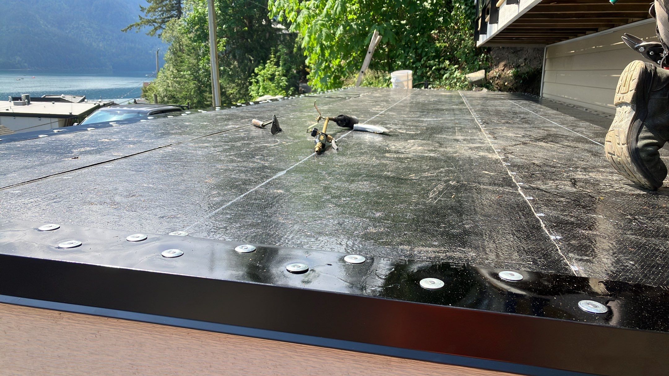 Small patio roof with 2ply sbs  by Top Notch Roofing Inc