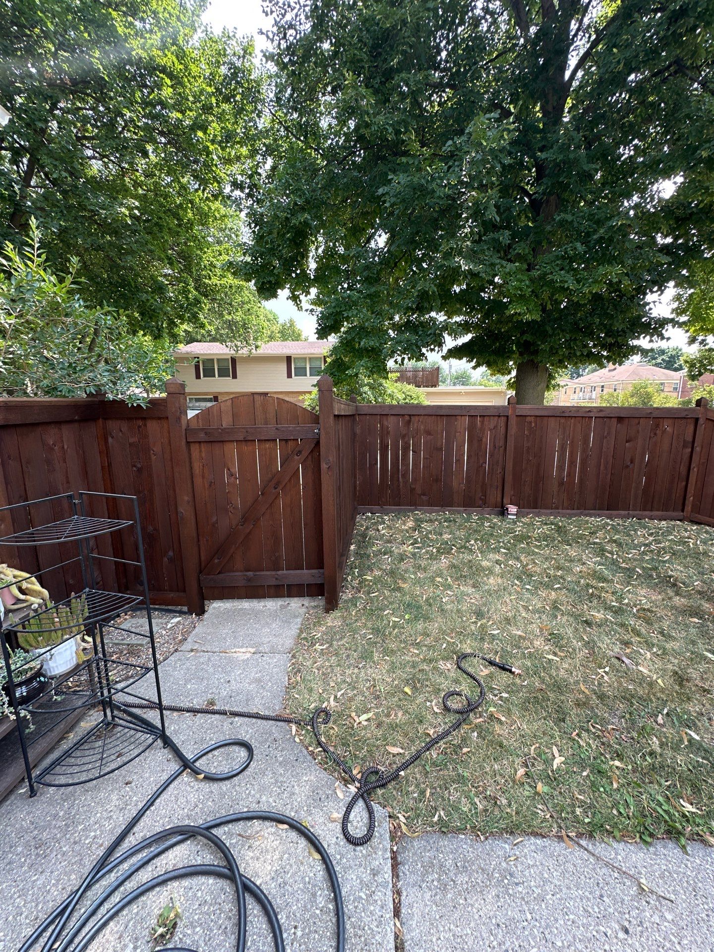 Dark Stained Privacy Fence and Composite Deck in Milwaukee by OCS Contracting Services