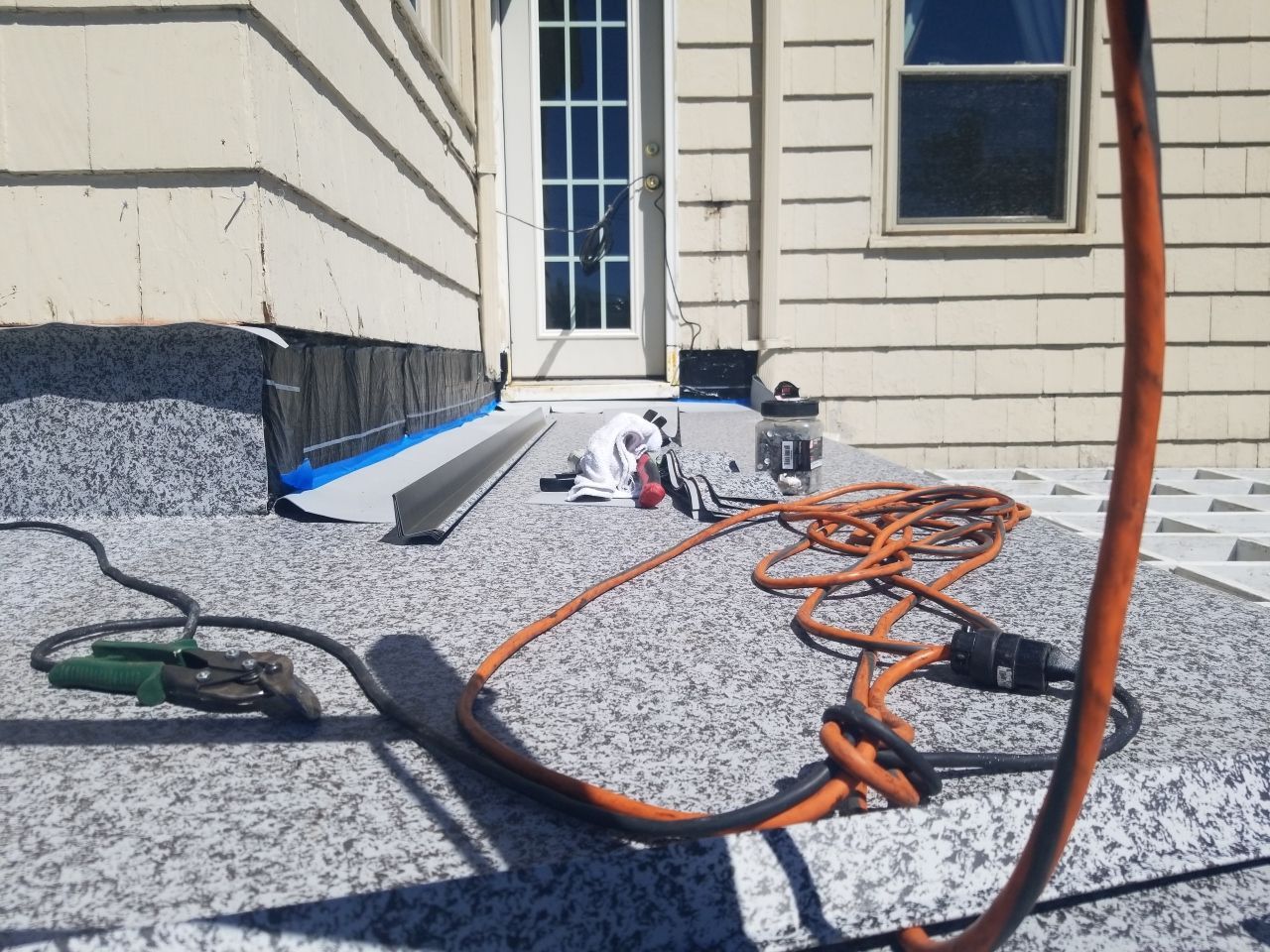 Residential Roofing Installation, Dec-tek walk-out porch roof, siding on garage by Absolute Roofing and Construction