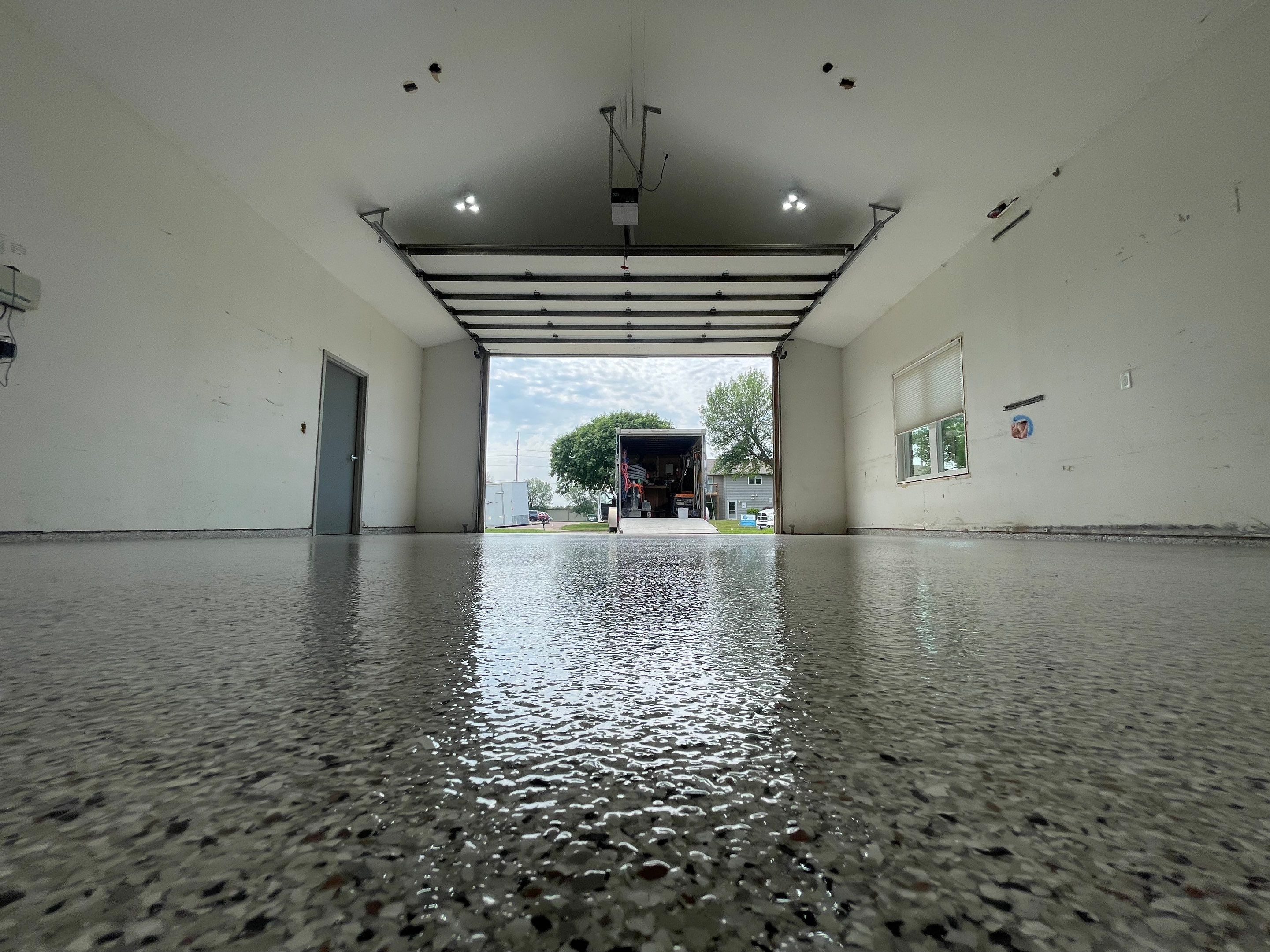 Coyote Flake Concrete Coating for Sioux Falls Garage by Select Painting, Coatings & Garage Cabinets