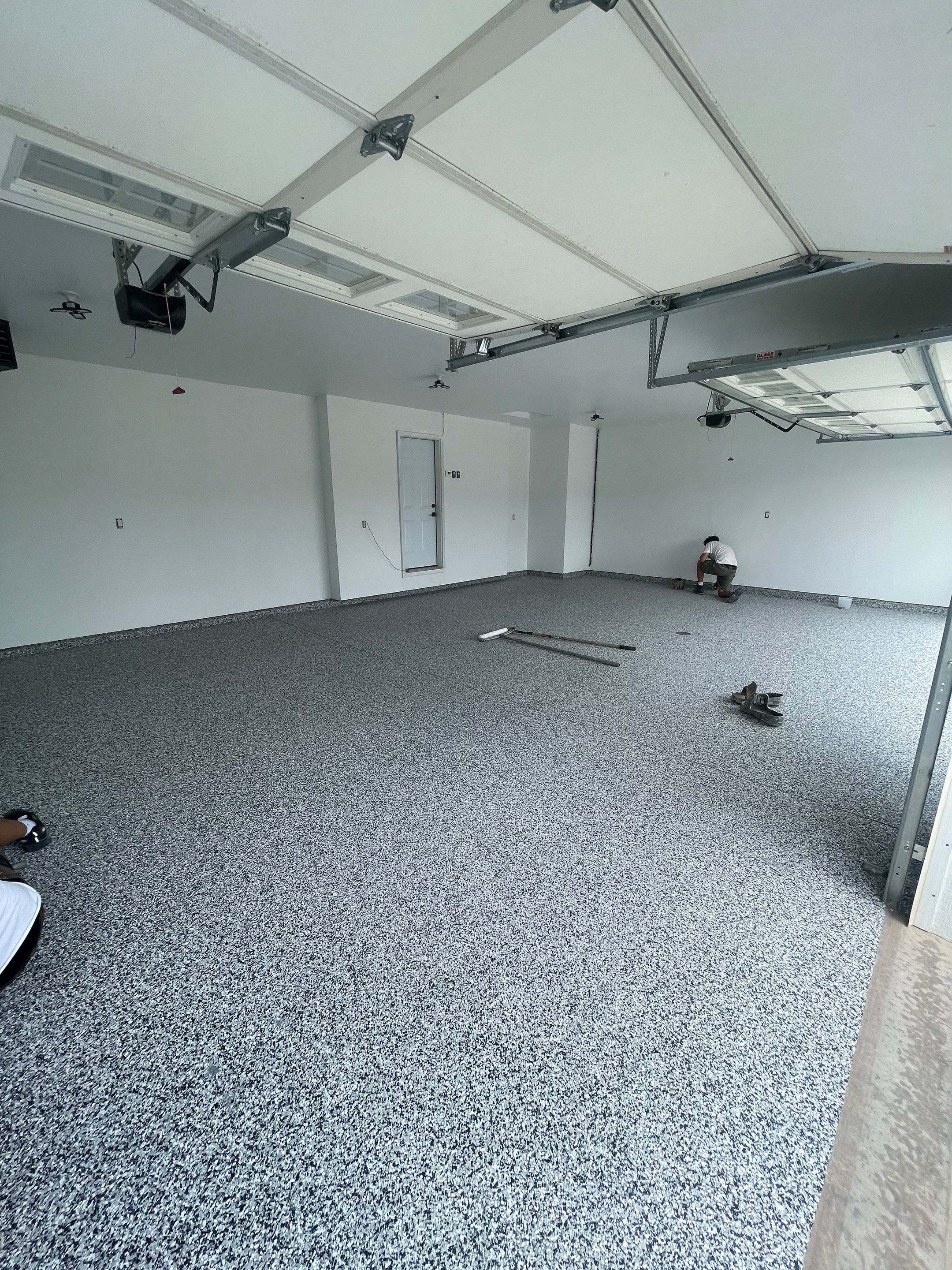 Grey Flake Epoxy Garage Floor Coating in Sioux Falls by Select Painting, Coatings & Garage Cabinets