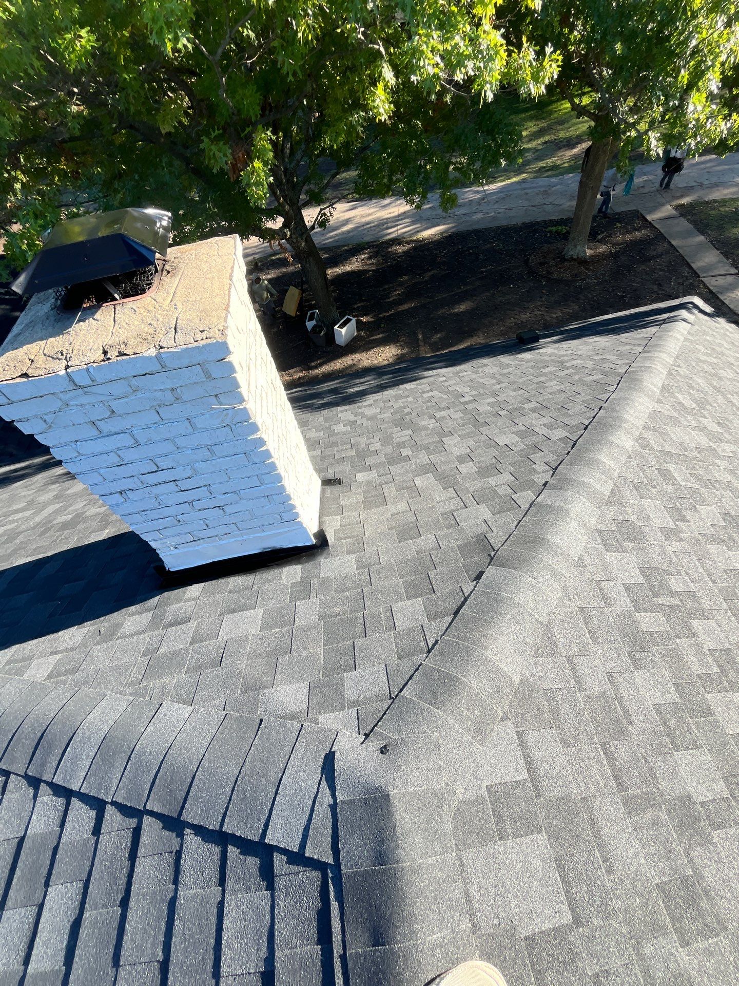 White brick with IKO Granite Black by Tejas Roofworks + Restoration