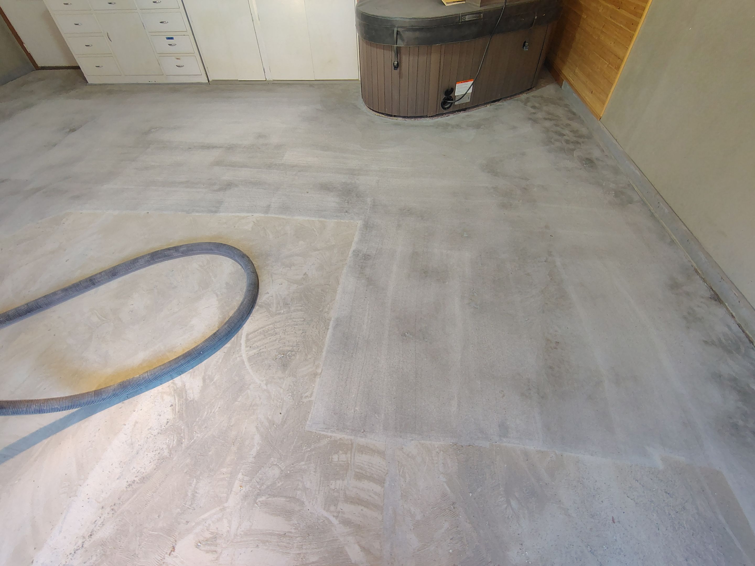 Domino Flake Garage Floor Coating Installation in Sioux Falls by Select Painting, Coatings & Garage Cabinets