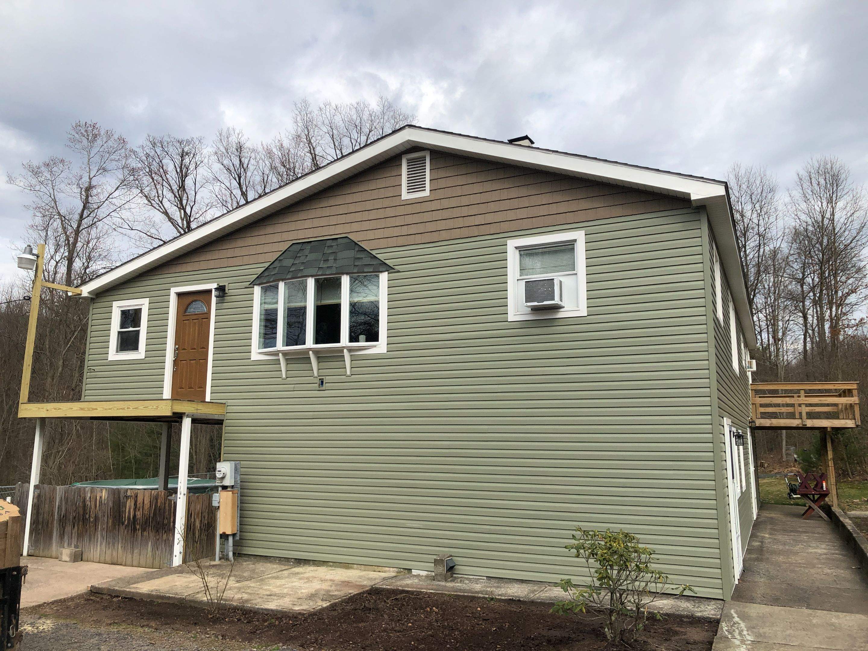 Sage Green Vinyl Siding and Exterior Trim Replacement in Ashland by Esh Builders