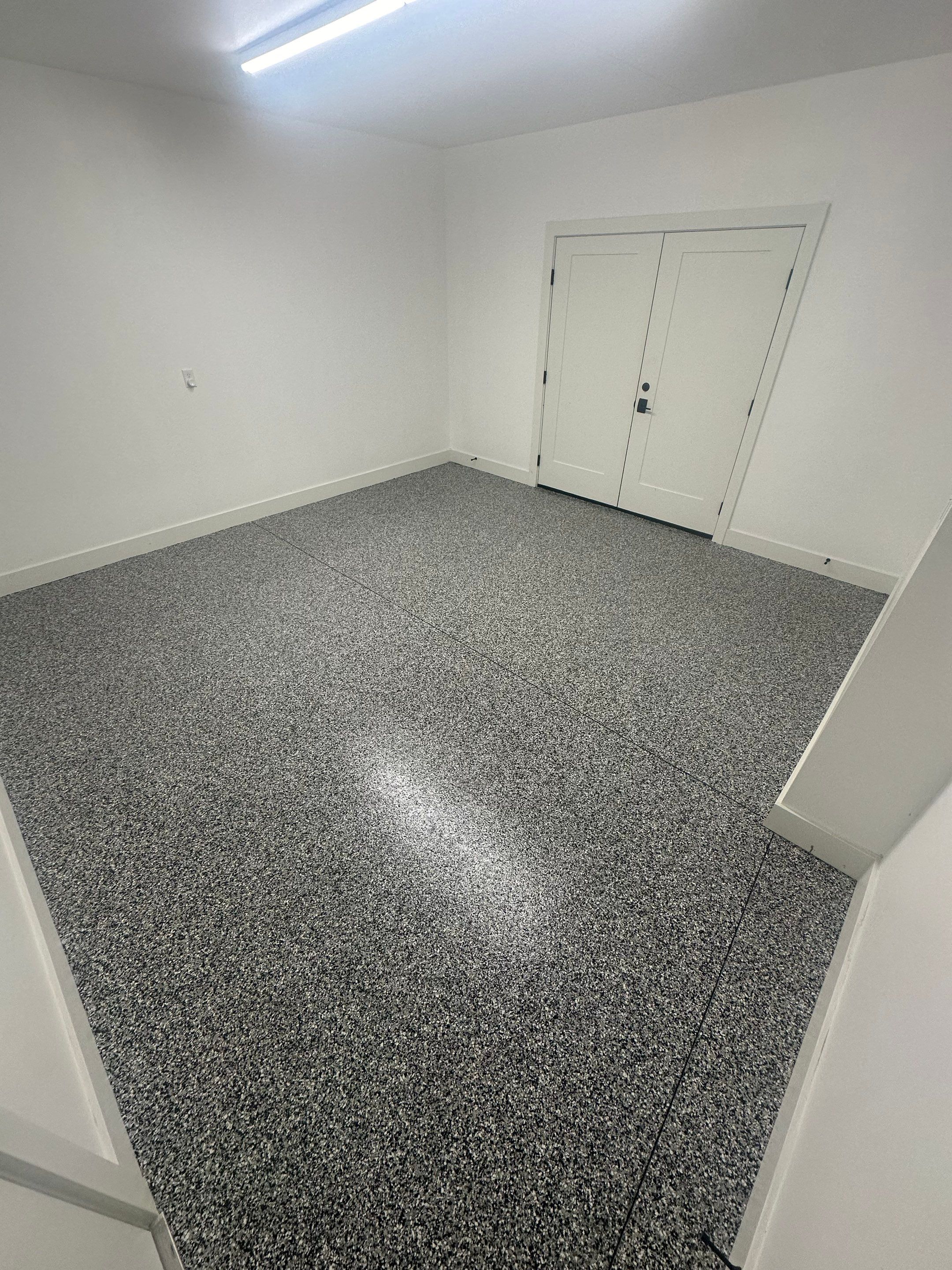 Multi-Color Epoxy Flake Garage Floor Installation in Sioux Falls by Select Painting, Coatings & Garage Cabinets