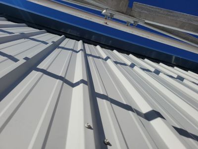 Exterior view of white ribbed metal roof panels