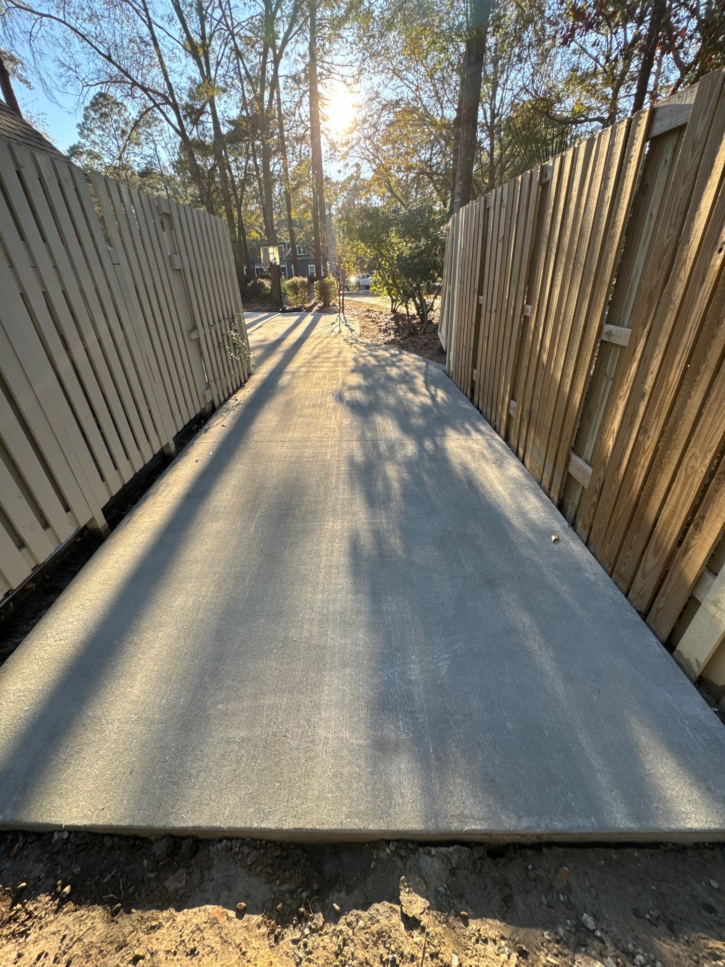 New Concrete Driveway and Privacy Fence Installation in Bluffton by Lowcountry Scapes, LLC