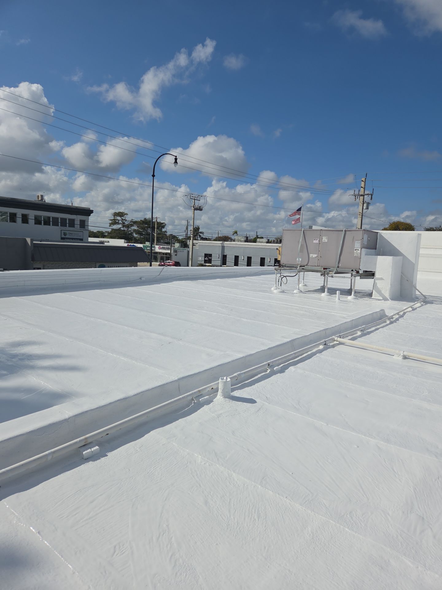 Commercial Flat Roof Restoration Using Silicone Coating in Hallandale Beach by Aastro Roofing