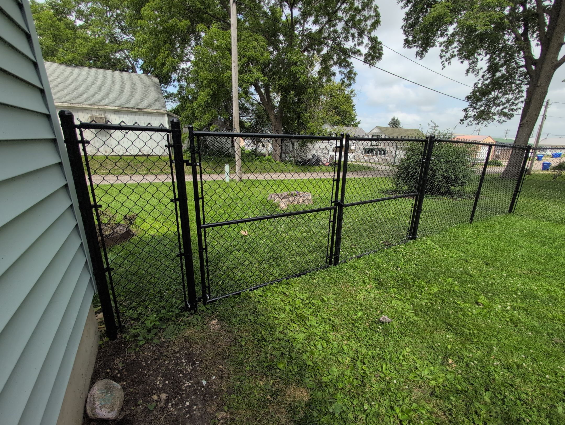 Black Vinyl Coated Chain Link Fence Installation in Independence by Perfect Picket Fence and Stain