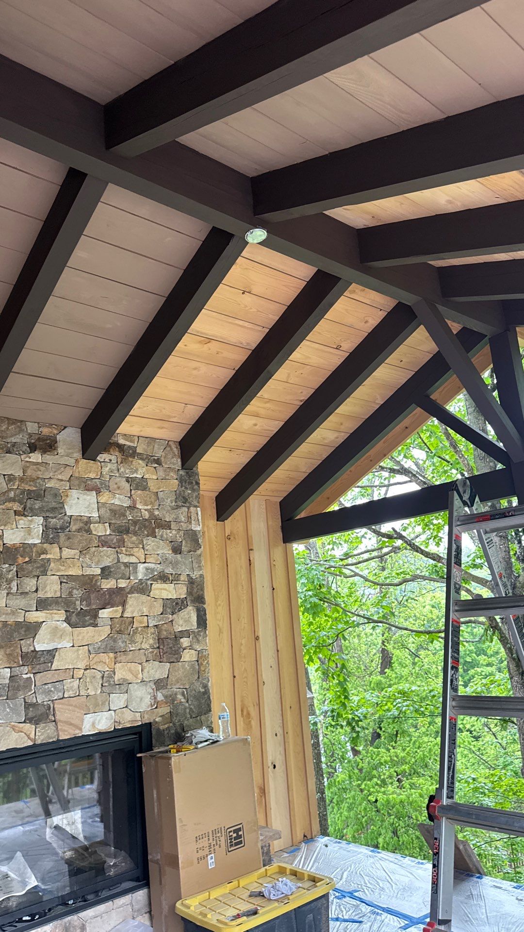 Custom Composite Deck with Stone Fireplace and Modern Cable Railing by Walnut Hollow Decks & Outdoor Living