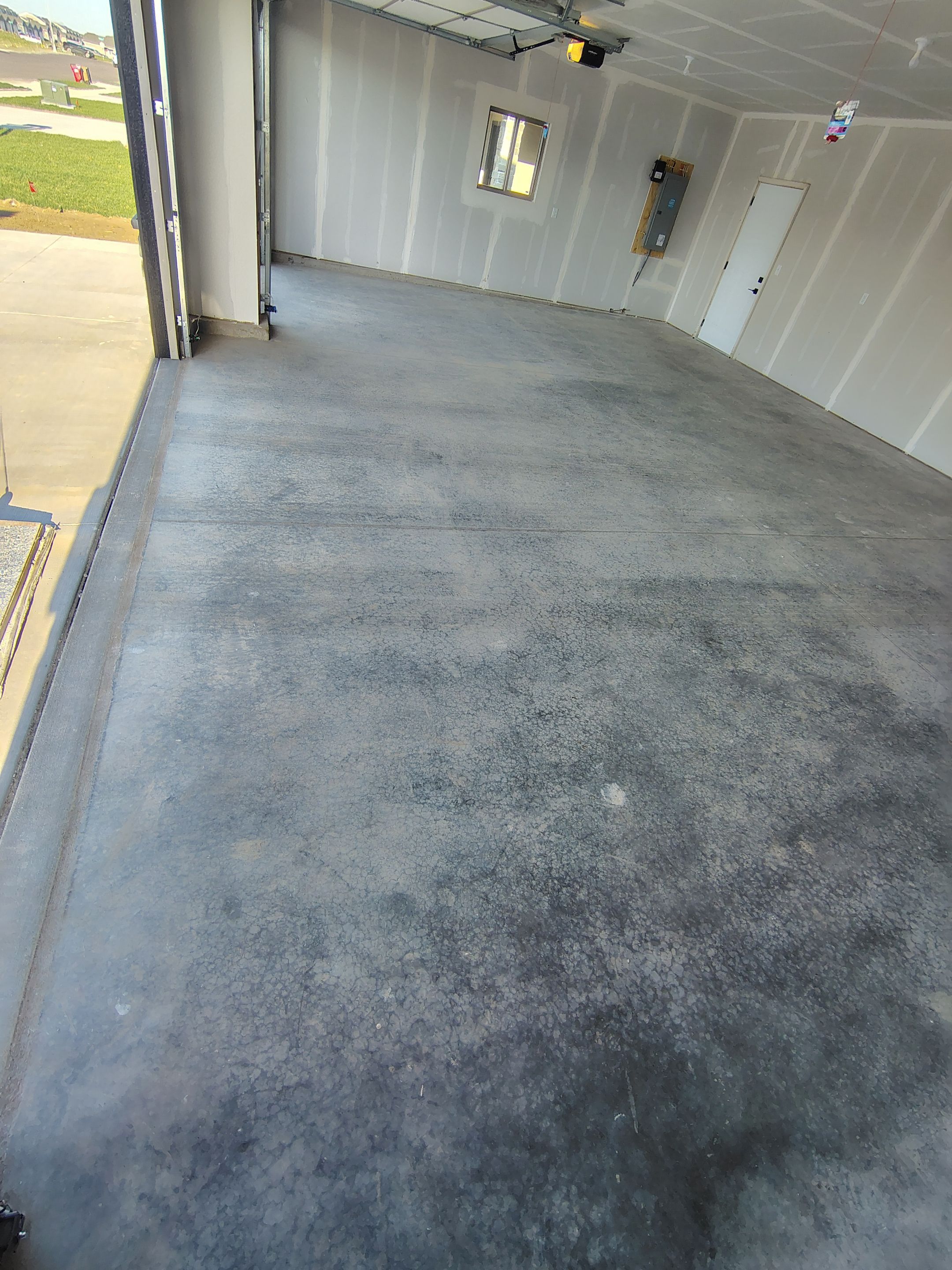 Speckled Epoxy Garage Floor Coating Installation in Sioux Falls by Select Painting, Coatings & Garage Cabinets