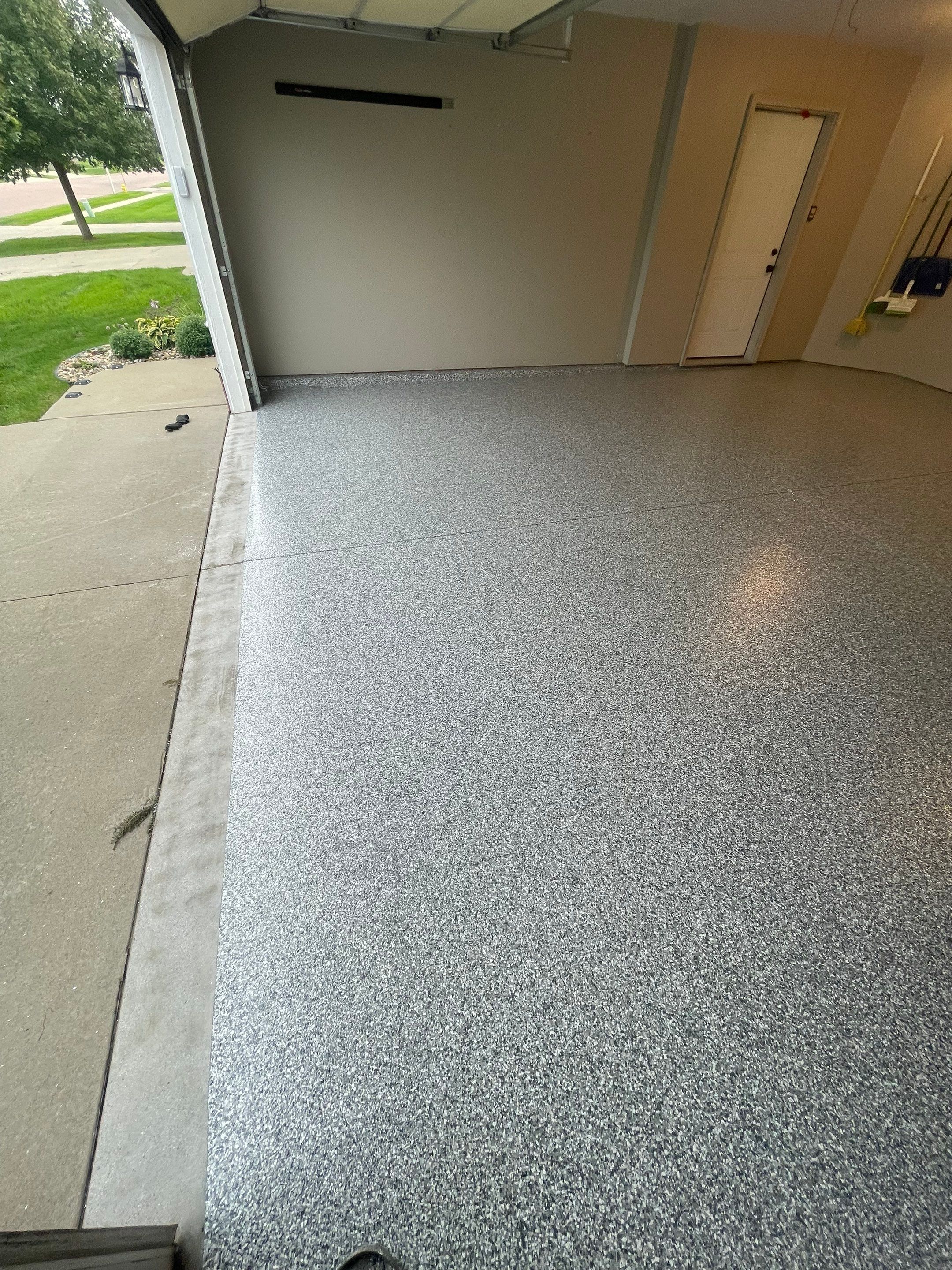 Custom Polyurea Flake Garage Floor Installation in Sioux Falls by Select Painting, Coatings & Garage Cabinets