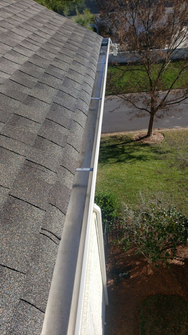 Sara Gutter cleanout using water by Power Wash Masters LLC