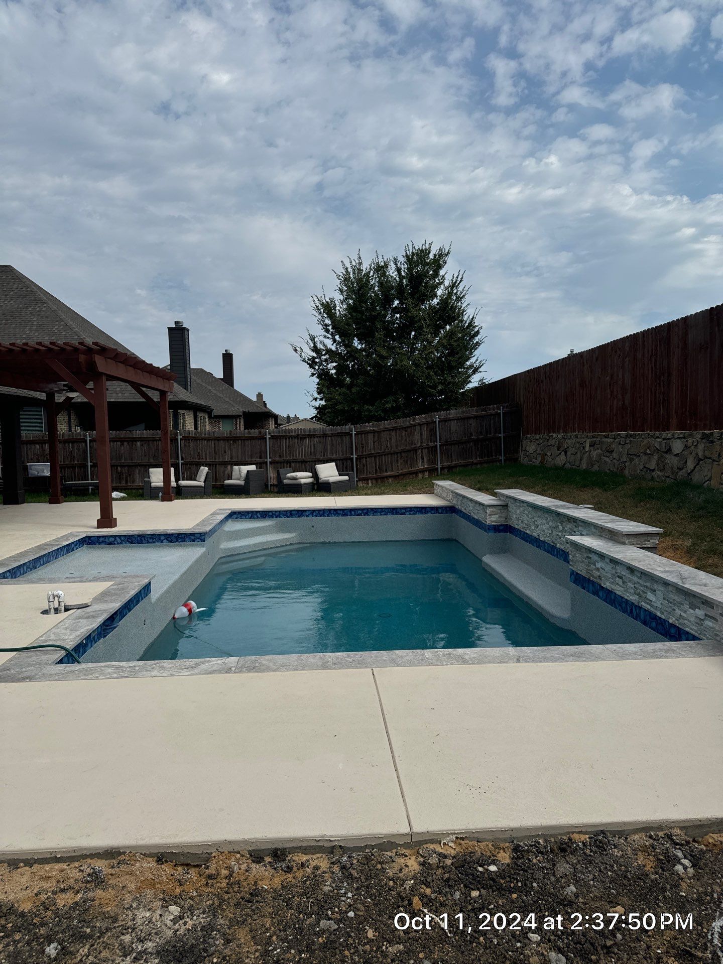 Modern Geometric Pool with Raised Stone Wall and Paver Deck by Pinnacle Pools and Spas - DFW