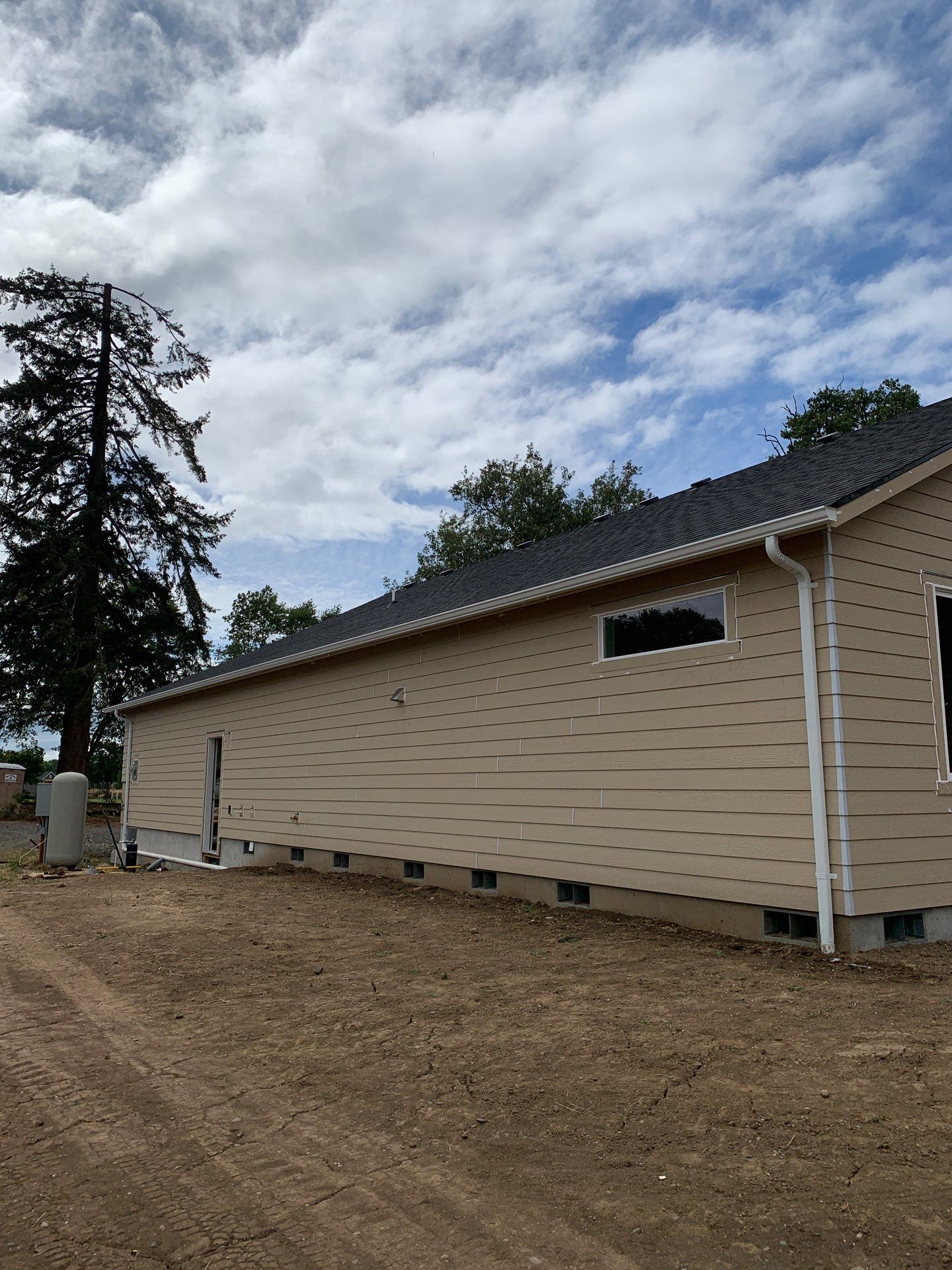 Seamless White Gutter Installation for Eugene New Construction Home by BEST Roofing & Waterproofing