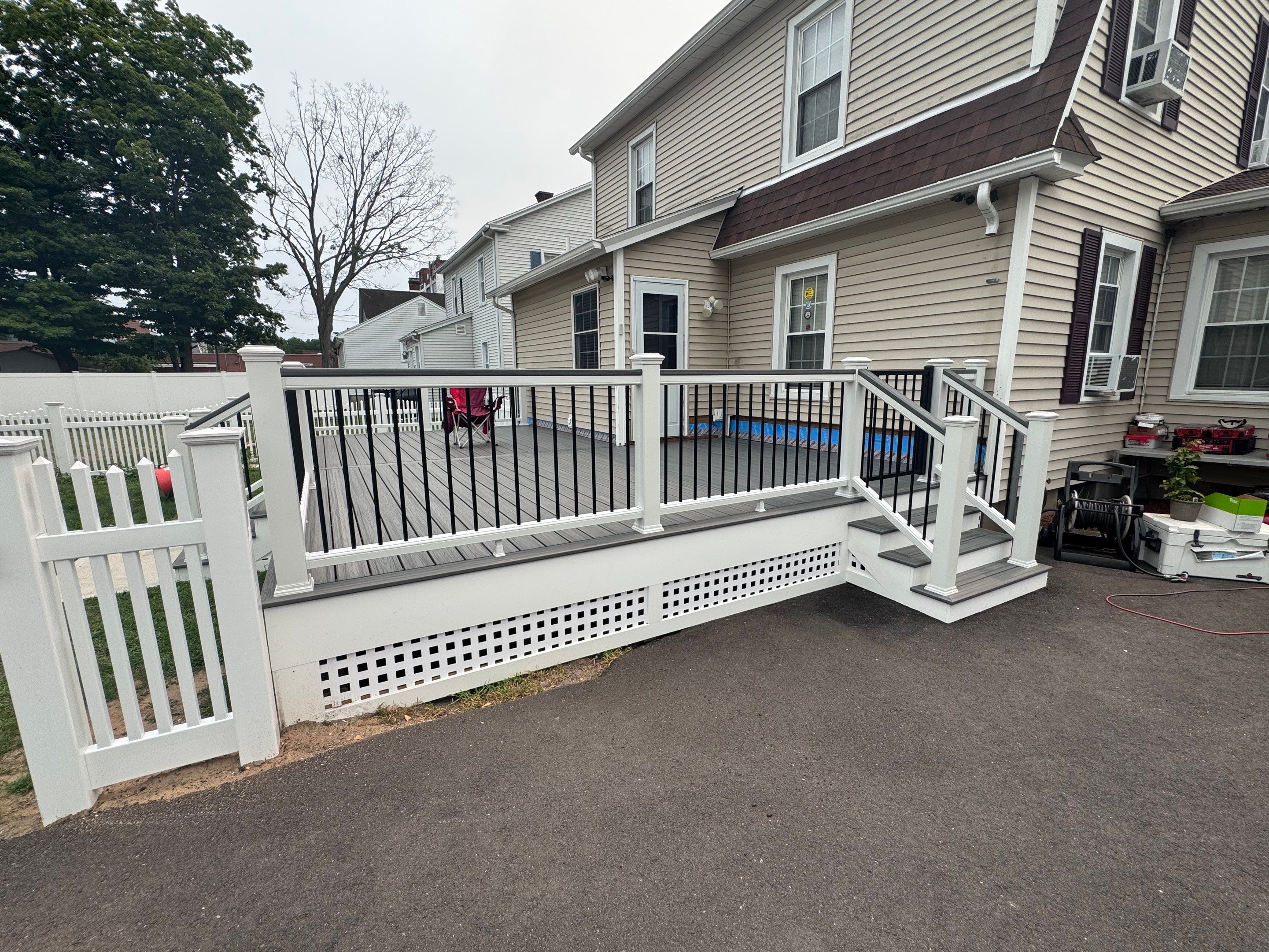 Deck Replacement usin gTrex Tropical Islandmist and Transcend Cocktail rail, Includes lattice and a gate. by DiGiorgi Roofing and Siding Inc