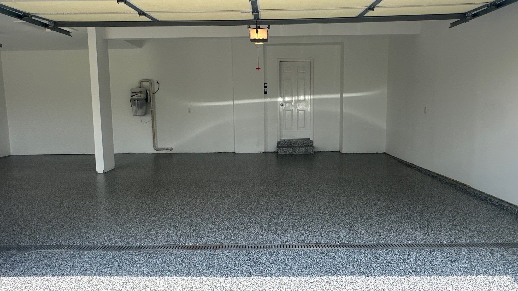 Laura B. garage transformation with a new floor and garage storage  by Banner Garage